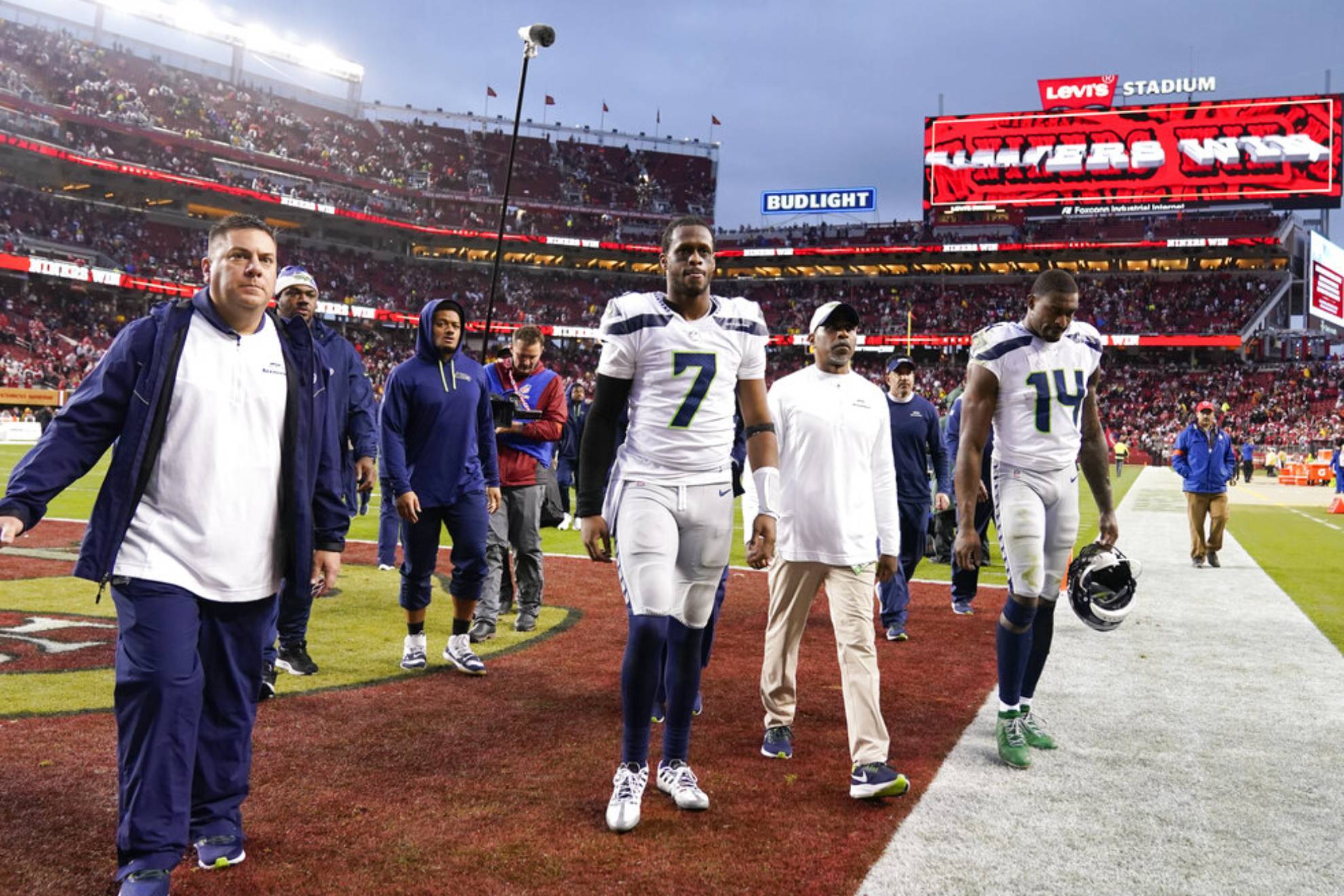 Seattle Seahawks quarterback Geno Smith (7) and wide receiver DK Metcalf (14) walk off the field after an NFL wild card playoff football game against the San Francisco 49ers in Santa Clara, Calif., Saturday, Jan. 14, 2023. The 49ers won 41-23.