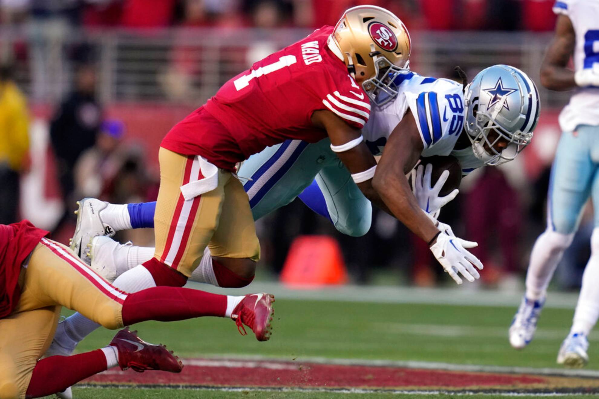 San Francisco 49ers cornerback Jimmie Ward (1) tackles Dallas Cowboys wide receiver Noah Brown during the first half of an NFL divisional round playoff football game in Santa Clara