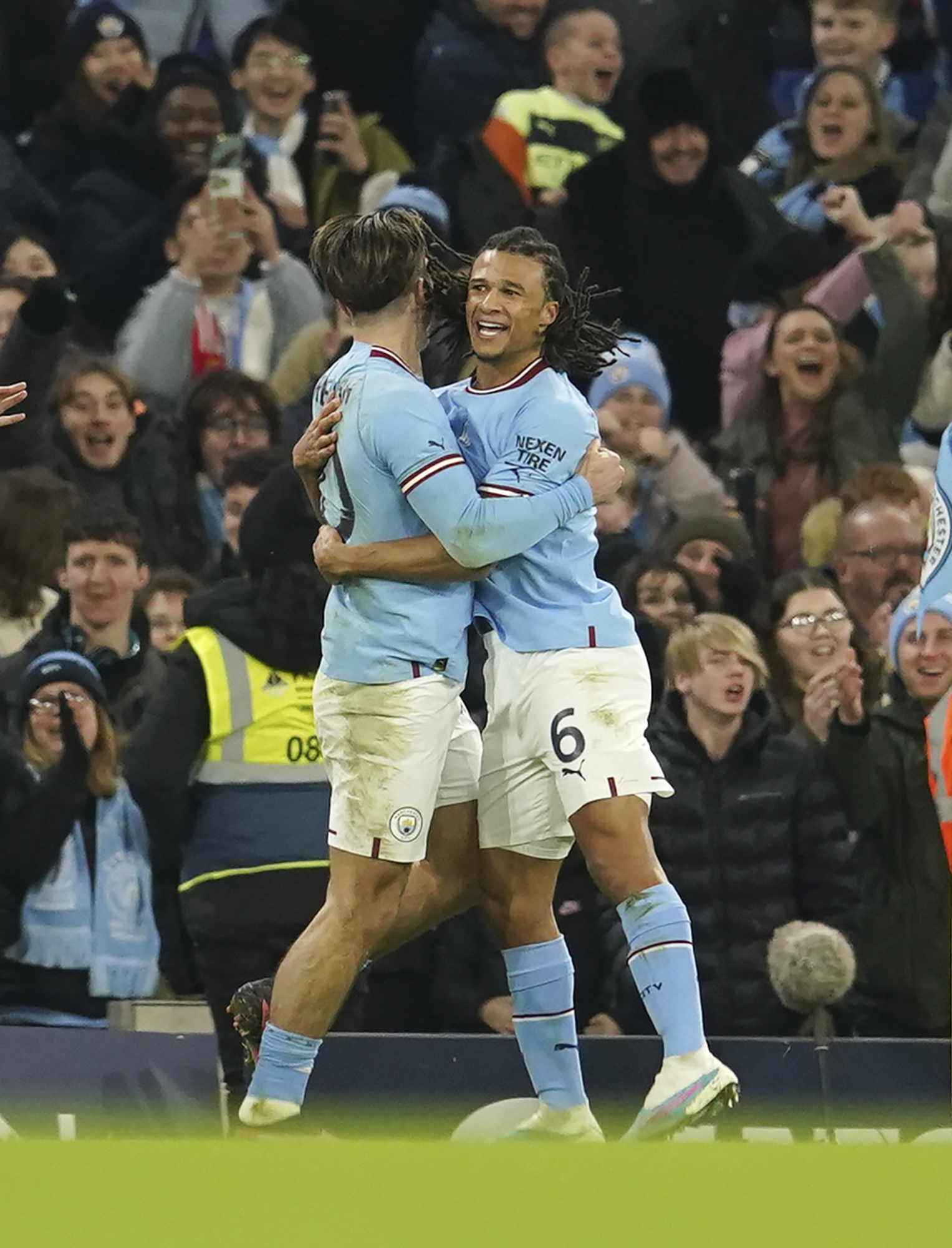 Manchester City's Nathan Ake, right, celebrates with his teammate Jack Grealish after scoring
