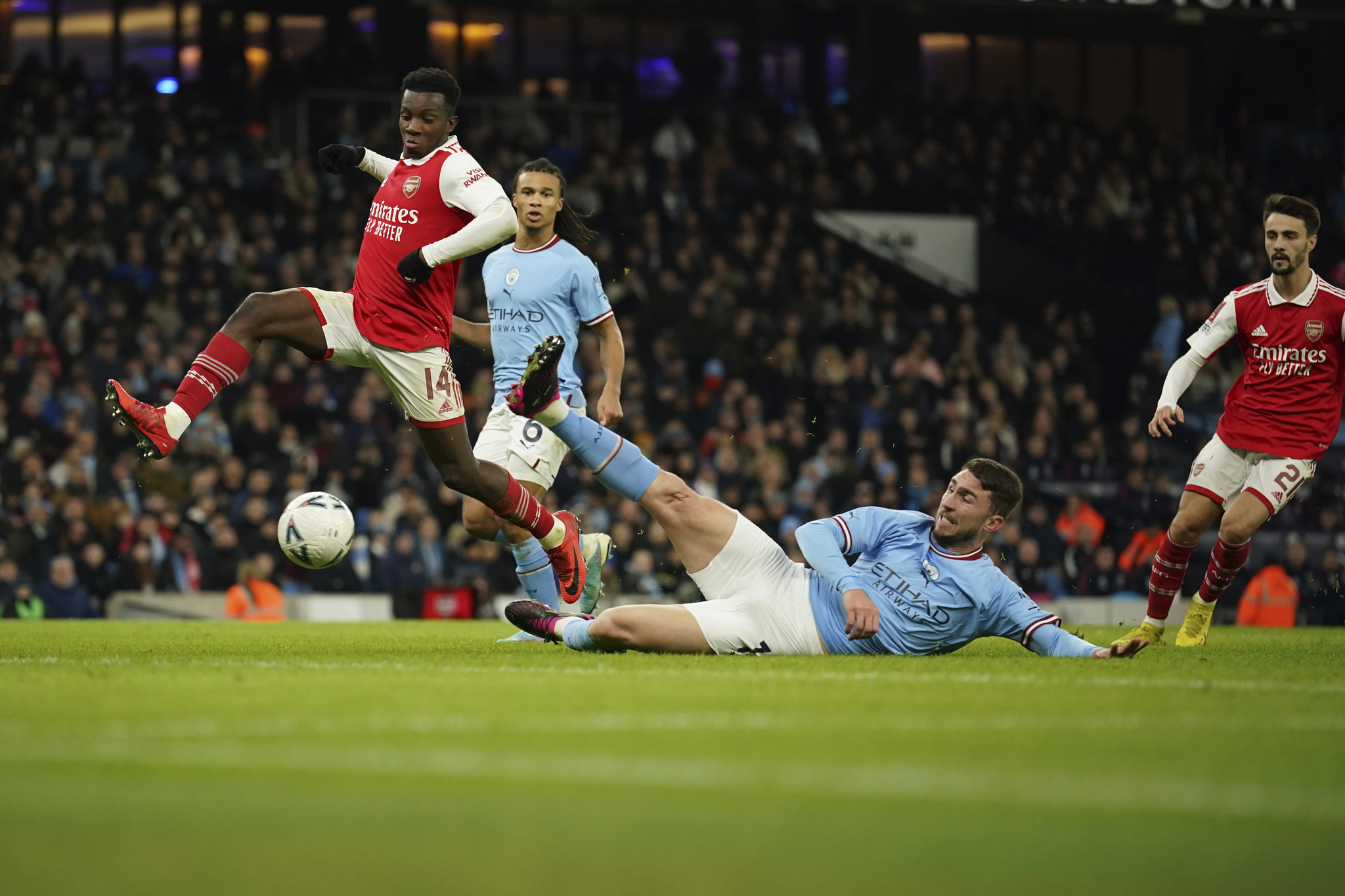 Arsenal's Eddie Nketiah, left, is tackled by Ruben Dias