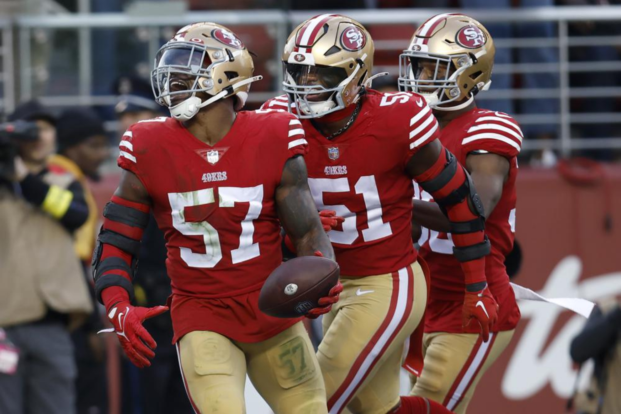 Dre Greenlaw with the ball in his hands while playing for the San Francisco 49ers.