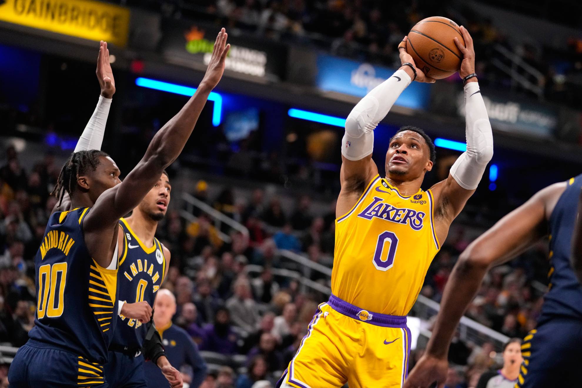 Los Angeles Lakers guard Russell Westbrook (0) shoots over Indiana Pacers guard Bennedict Mathurin (00) during the first half of an NBA basketball game in Indianapolis