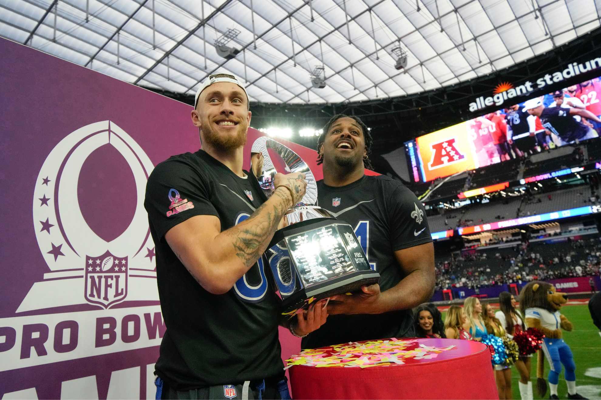 NFC tight end George Kittle, left, of the 49ers, and defensive end Cameron Jordan of the New Orleans Saints hold the trophy after the NFC defeated AFC at the NFL Pro Bowl games.
