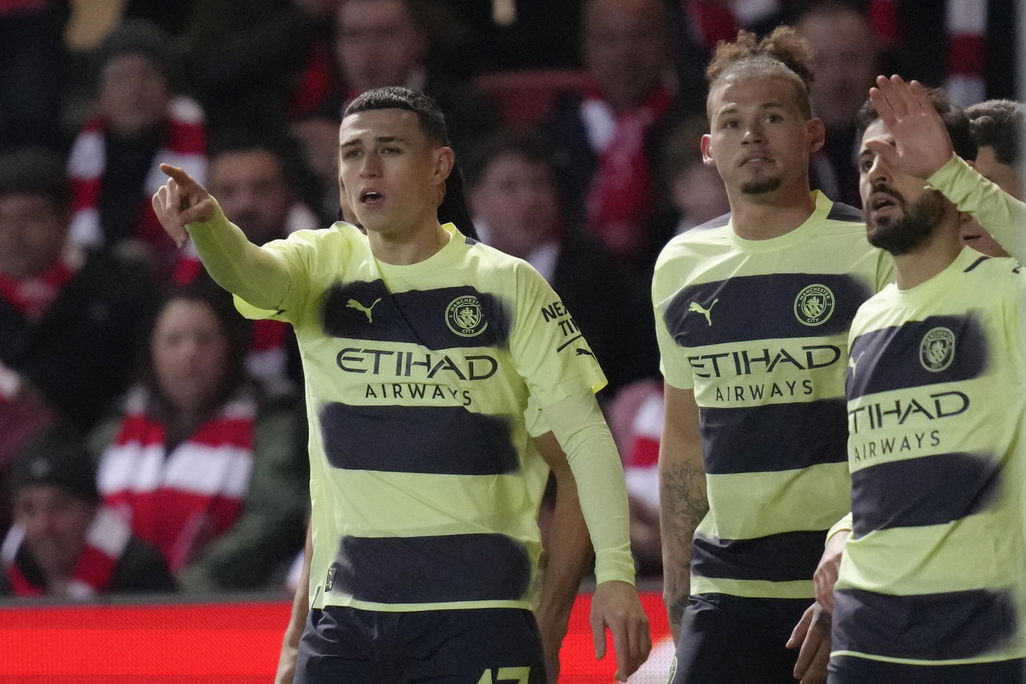 Manchester City's Phil Foden, left, celebrates with his teammates after scoring