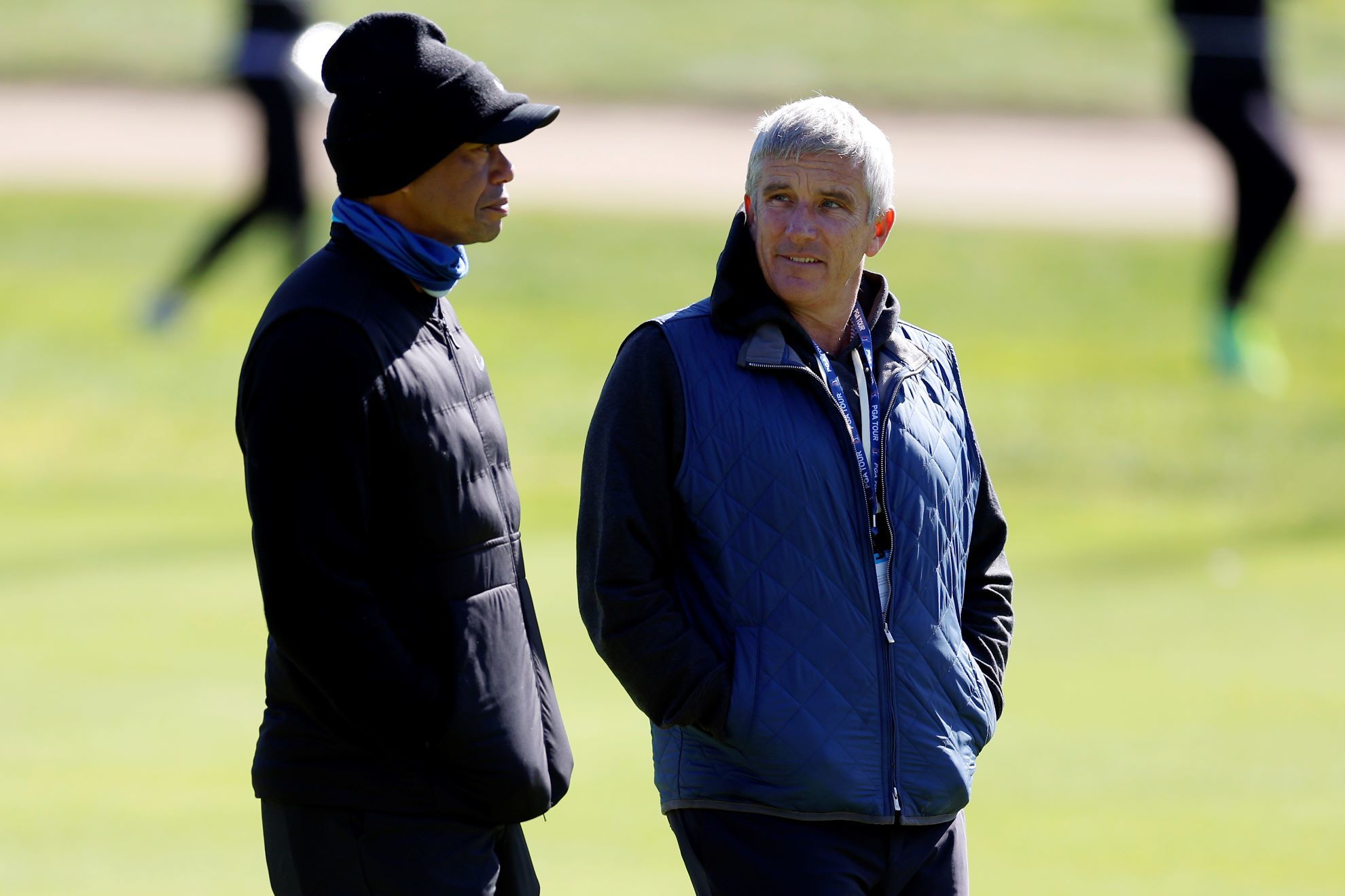 Tiger Woods, left, talks to PGA Commissioner Jay Monahan.