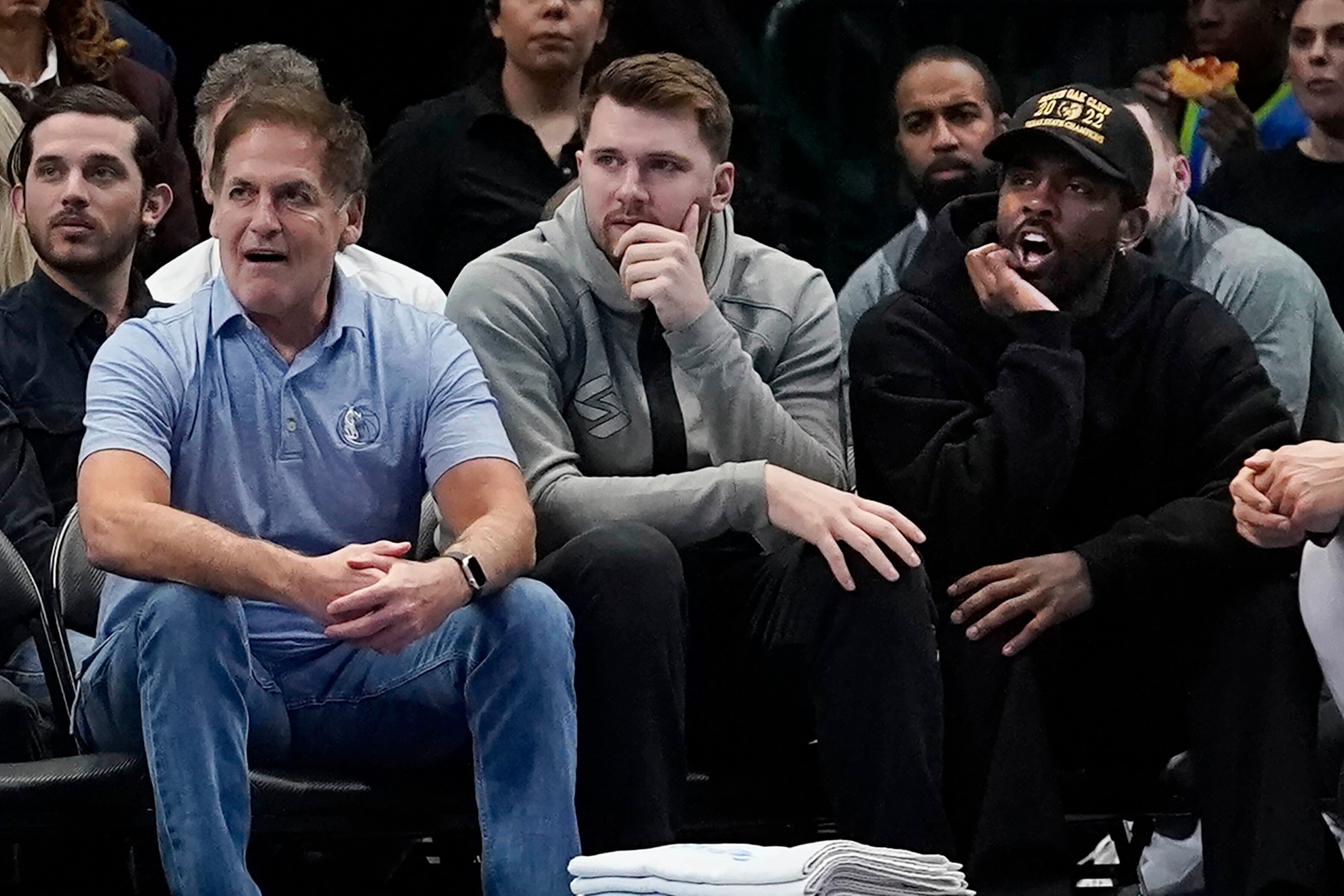 Mark Cuban sitting with Luka Doncic and Kyrie Irving