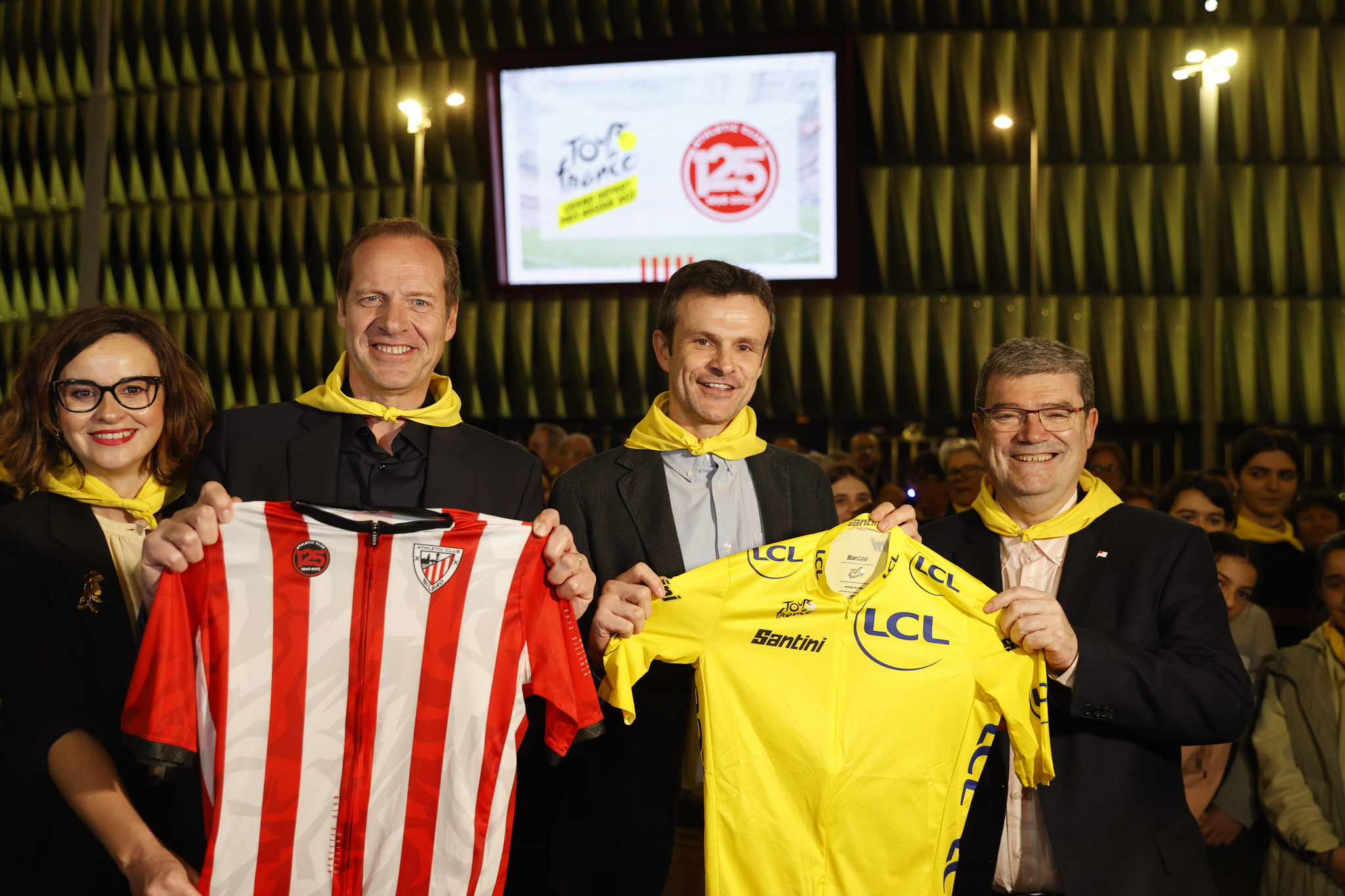 Aburto y Uriarte sostienen un maillot de líder del Tour y Prudhomme, director de la prueba, un maillot del Athletic en uno de los actos del pasado miércoles.