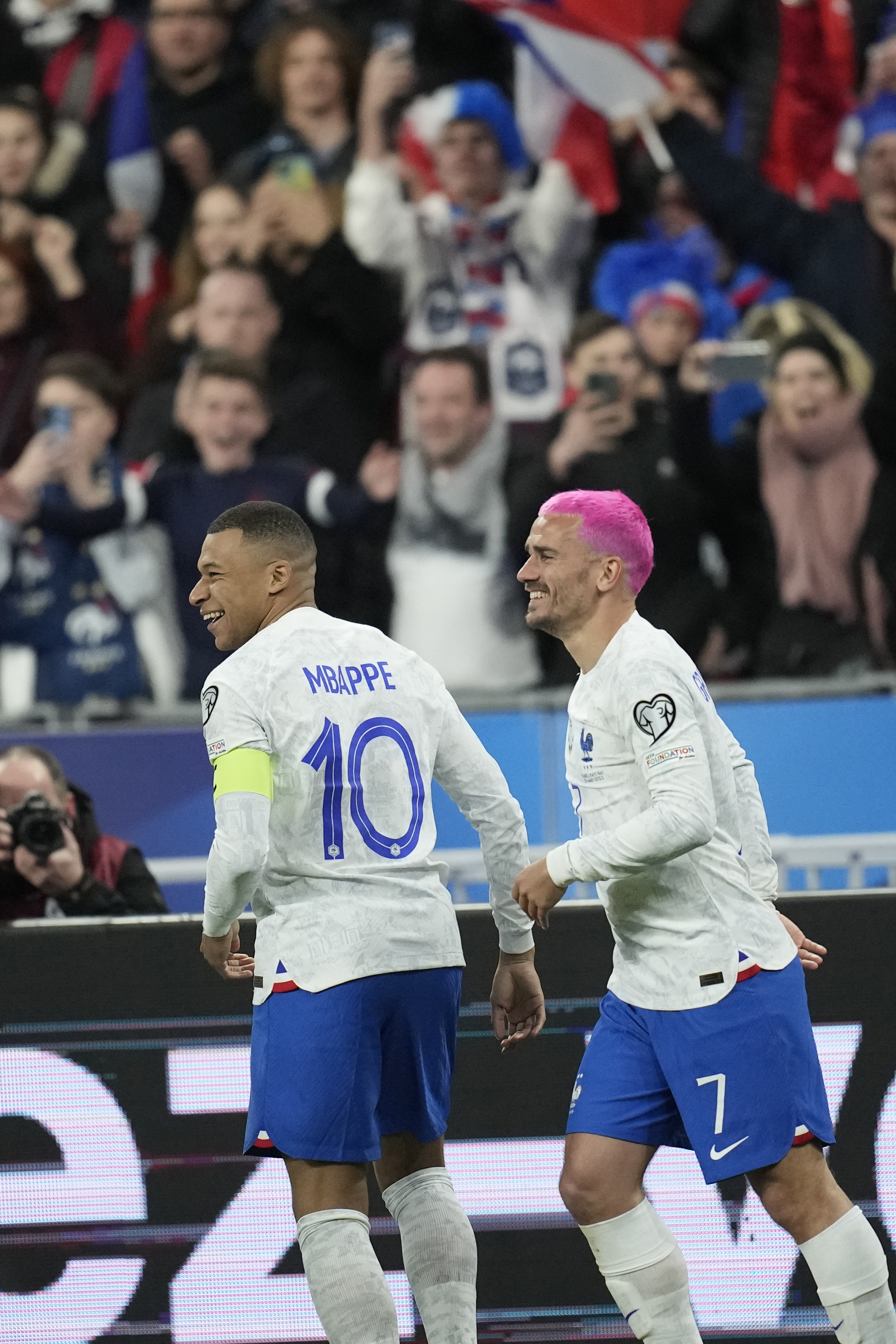 France's Antoine Griezmann, right, celebrates with Kylian Mbappe
