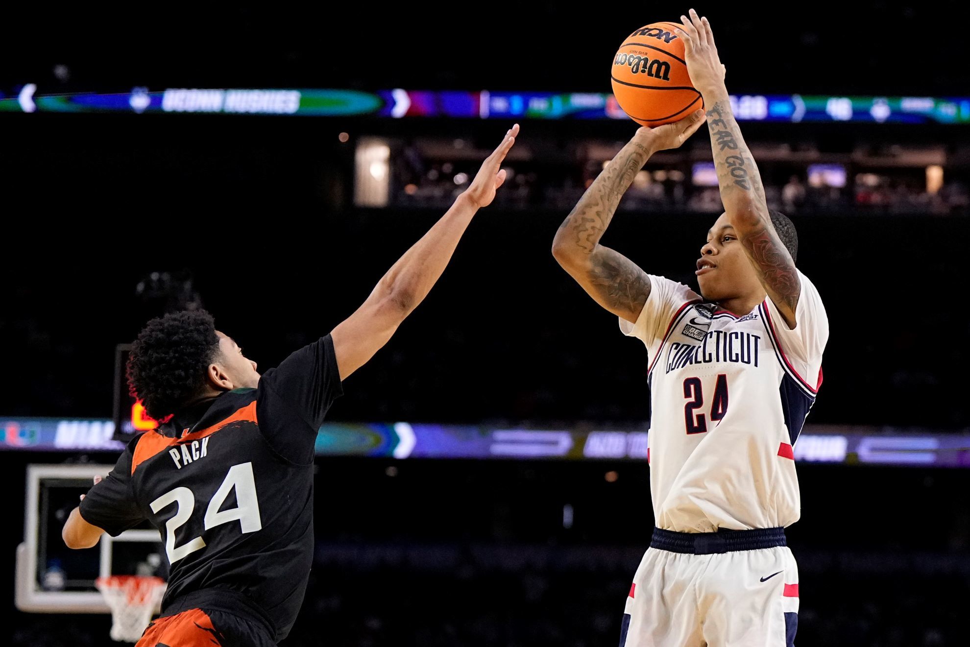 Connecticut guard Jordan Hawkins shoots over Miami guard Nijel Pack during the second half of a Final Four .