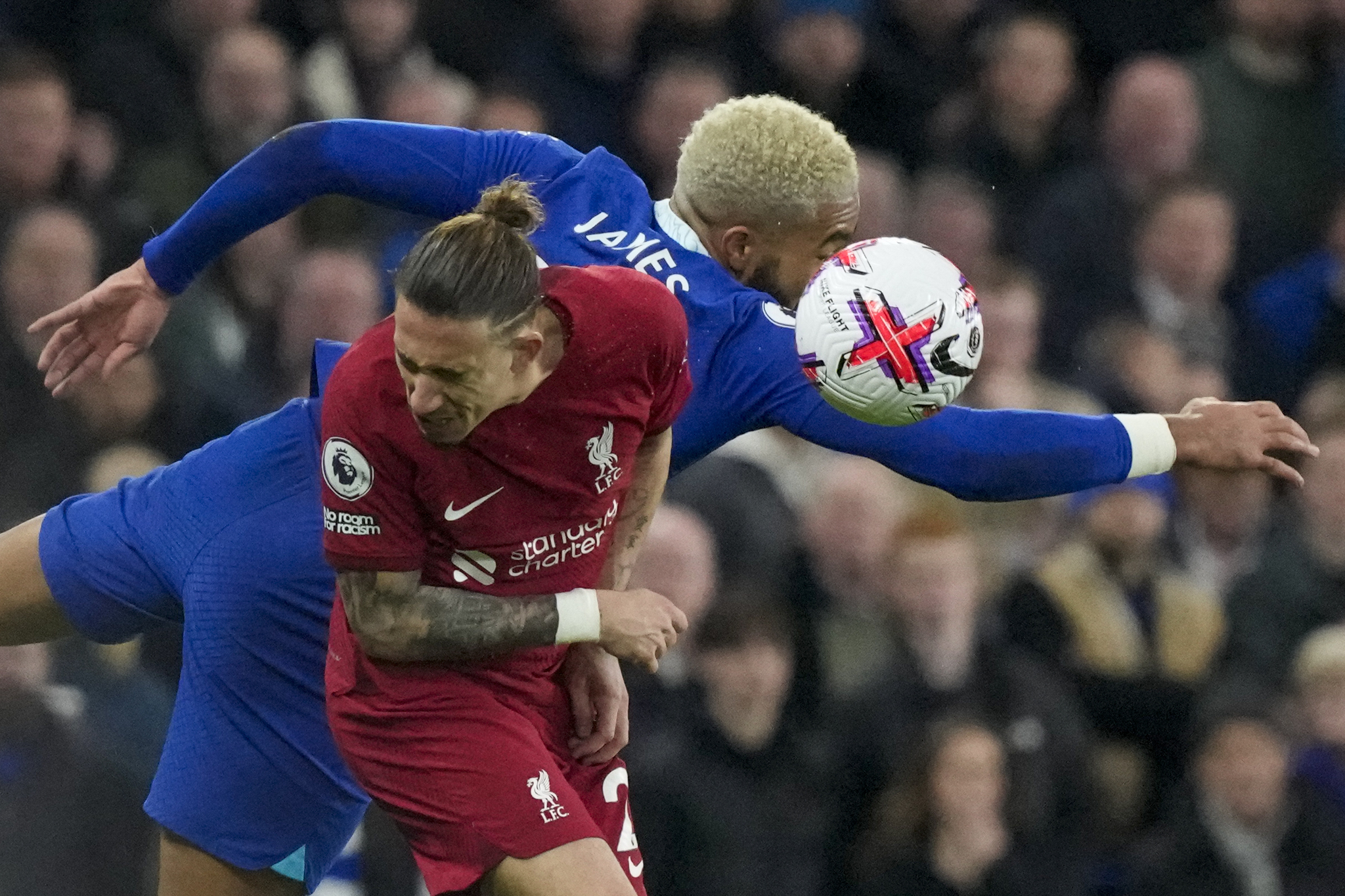 Liverpool's Kostas Tsimikas, front, jumps for the ball with  lt;HIT gt;Chelsea lt;/HIT gt;'s Reece James during the English Premier League soccer match between  lt;HIT gt;Chelsea lt;/HIT gt; and Liverpool at Stamford Bridge stadium in London, Tuesday, April 4, 2023. (AP Photo/Frank Augstein)