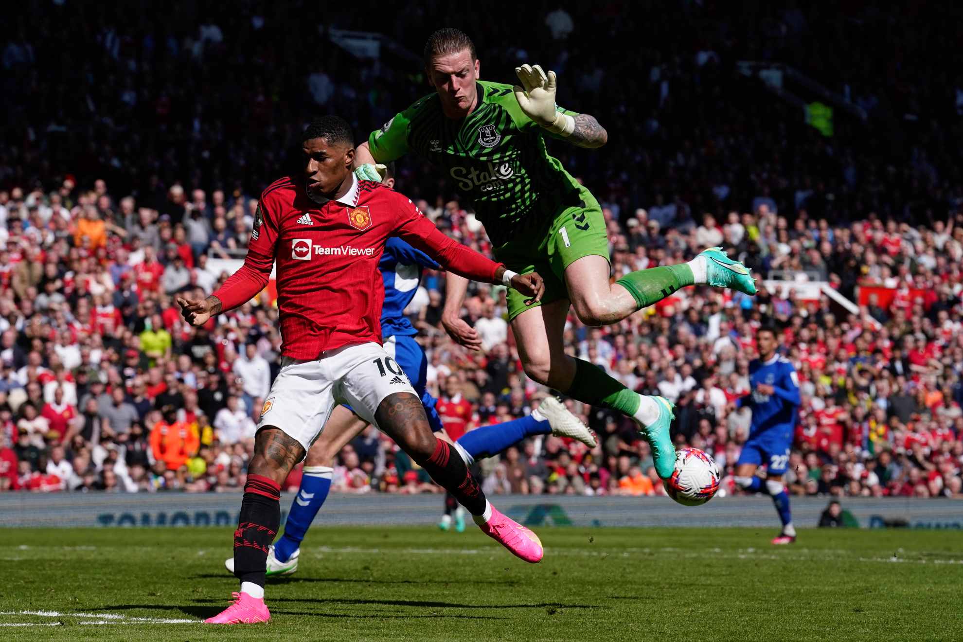 Everton's goalkeeper Jordan Pickford saves on an attempt to score by Manchester United's Marcus Rashford .
