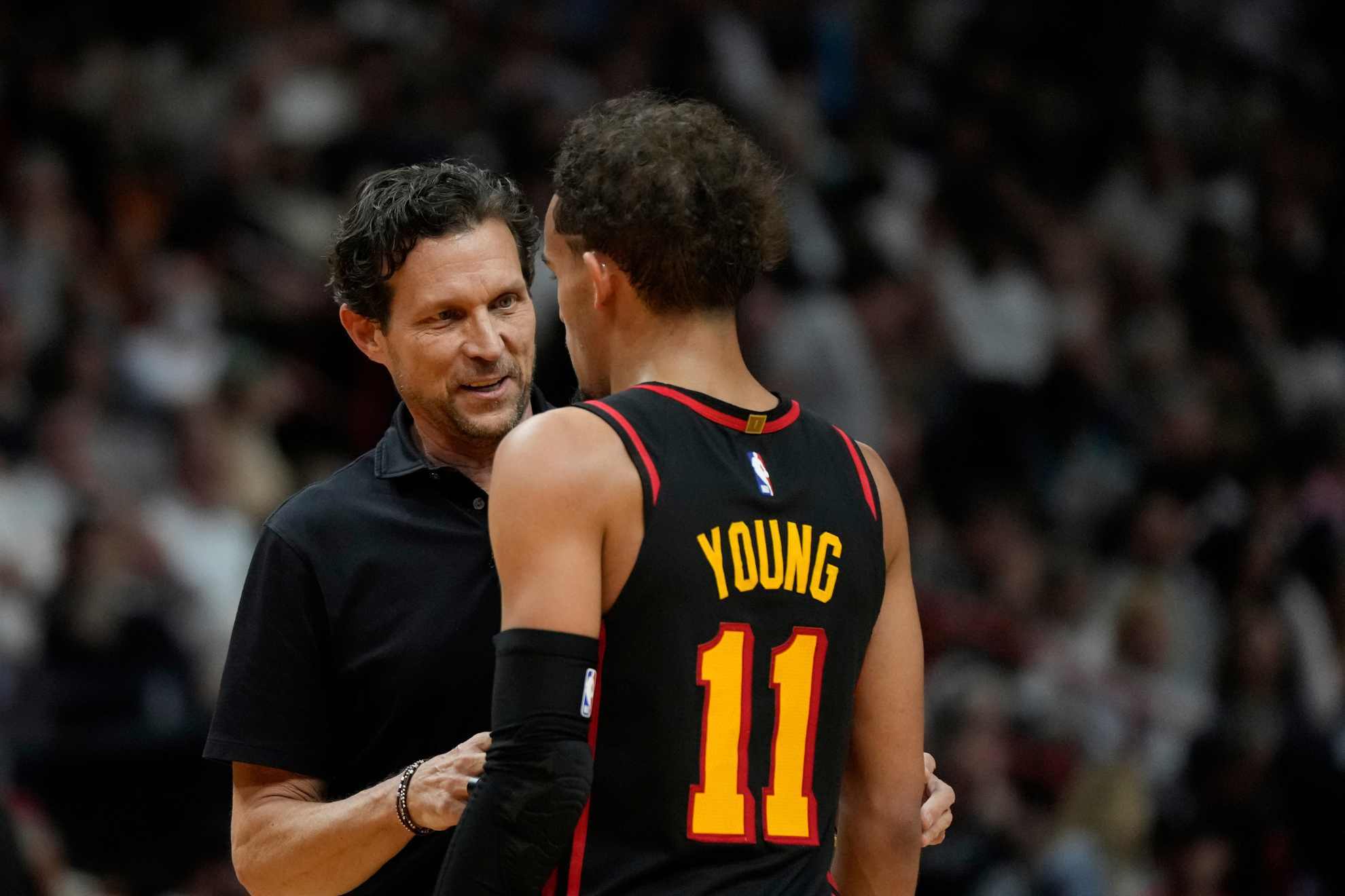 Atlanta Hawks coach Quin Snyder talks with guard Trae Young (11) during the second half of an NBA basketball play-in tournament game against the Miami Heat.