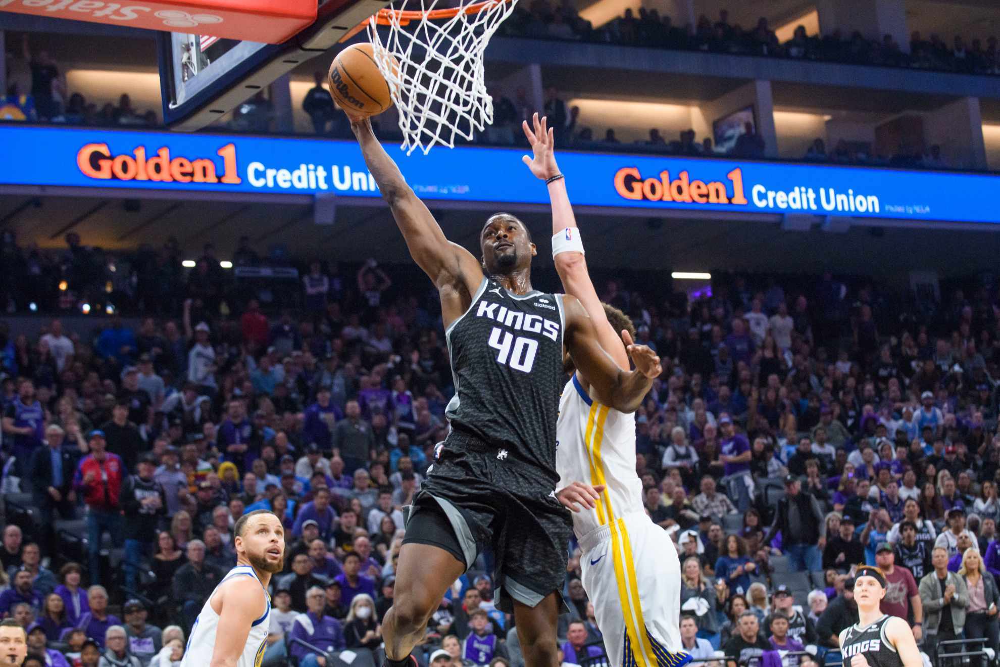 Sacramento Kings forward Harrison Barnes (40) lays up the ball over Golden State Warriors guard Klay Thompson.