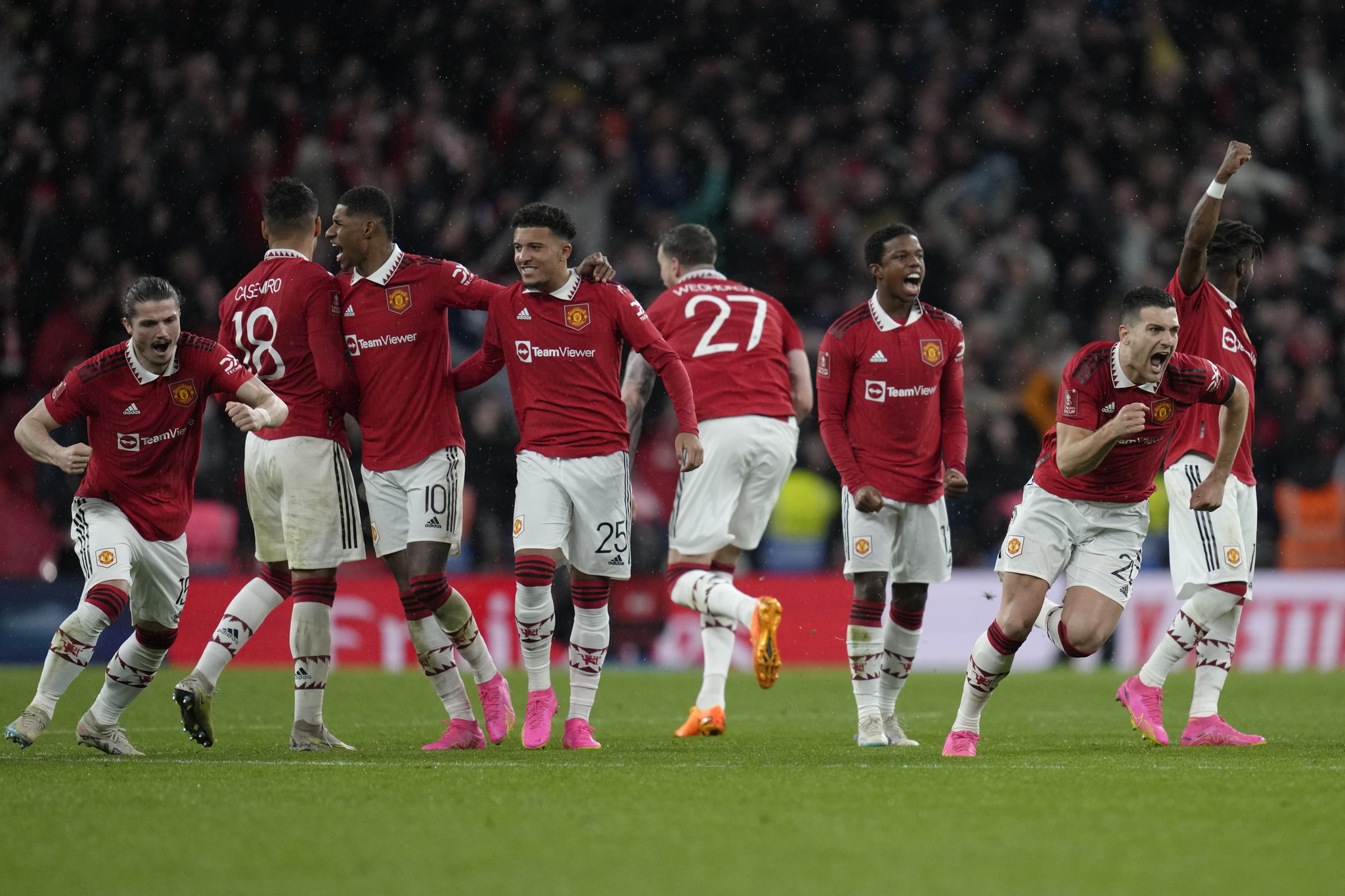 Manchester United players celebrate after winning on penalties.