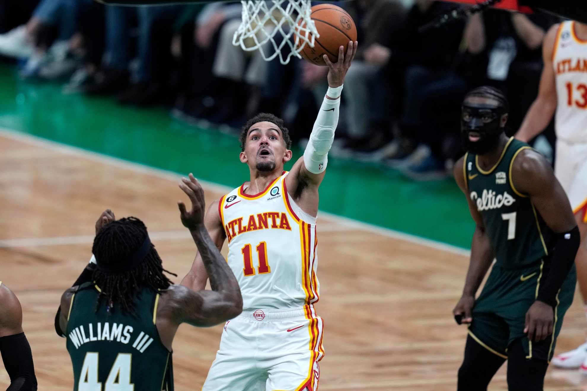 Hawks star Trae Young drives to the basket against Boston Celtics center Robert Williams III.