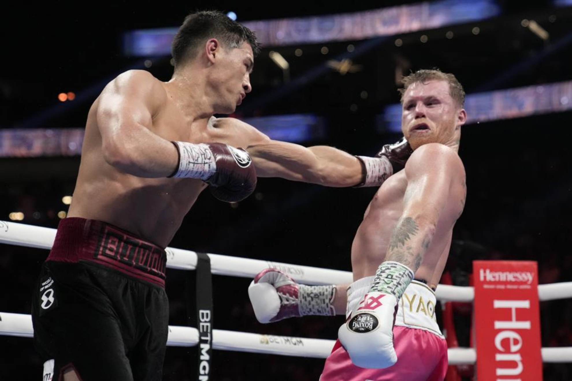 Dmitry Bivol, left, of Kyrgyzstan, throws a punch against Canelo Alvarez, of Mexico, during a light heavyweight title fight, Saturday, May 7, 2022, in Las Vegas
