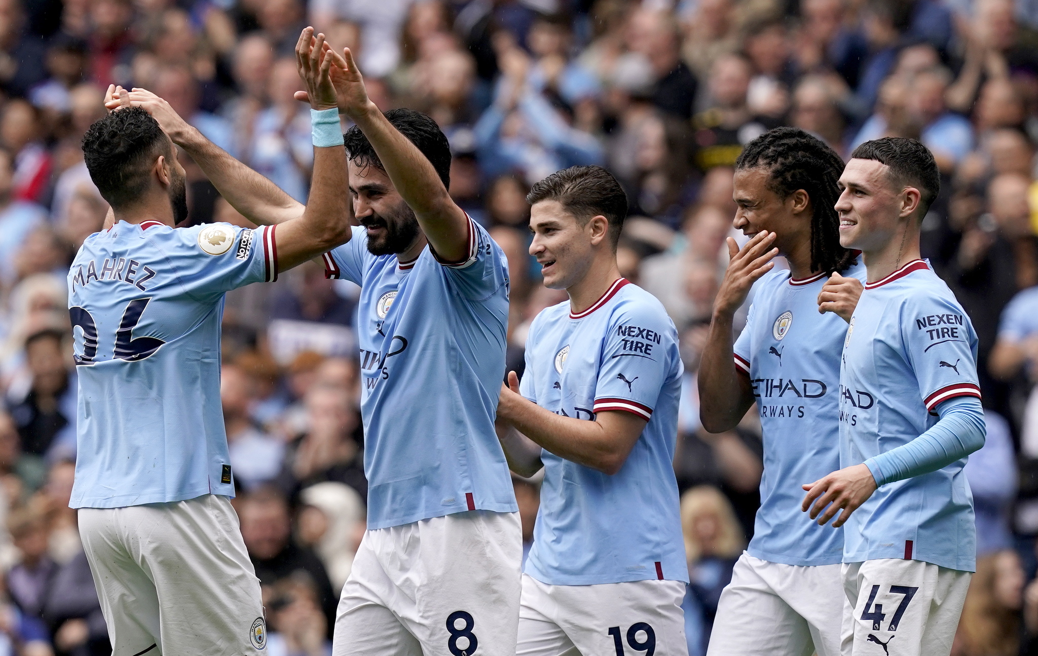 Manchester City captain Ilkay Guendogan (2R) celebrates with teammates
