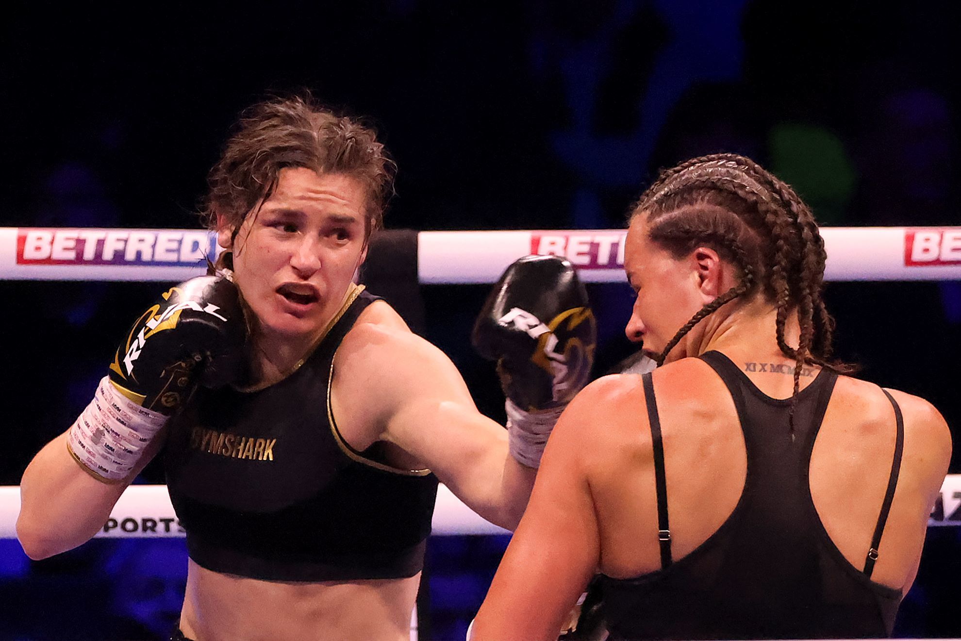 Katie Taylor lands a punch on Britain's Chantelle Cameron during their light-welterweight boxing world title fight.