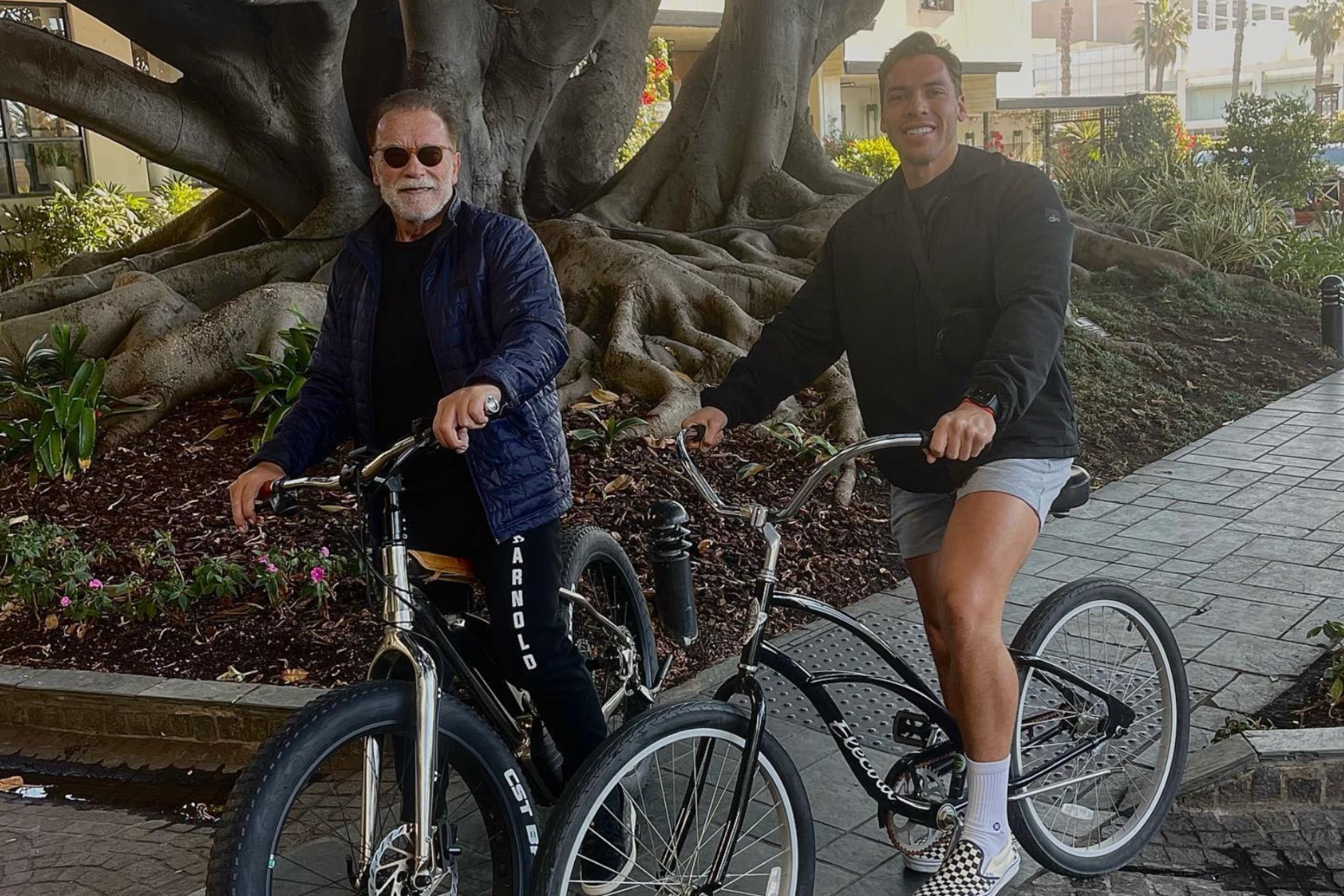 Arnold Schwarzenegger with son Joseph having a bike ride.