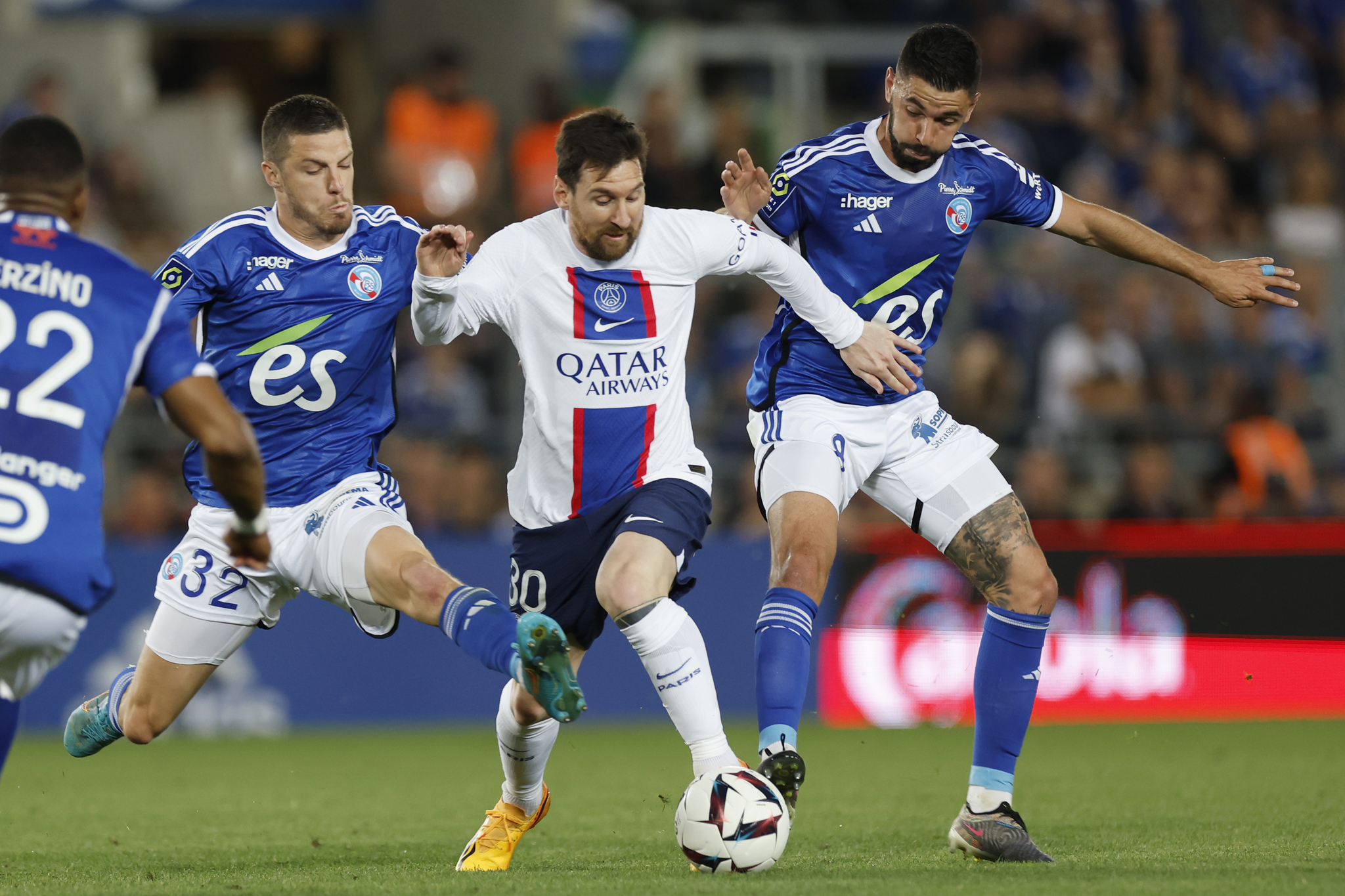 Messi fights off the Strasbourg defence.