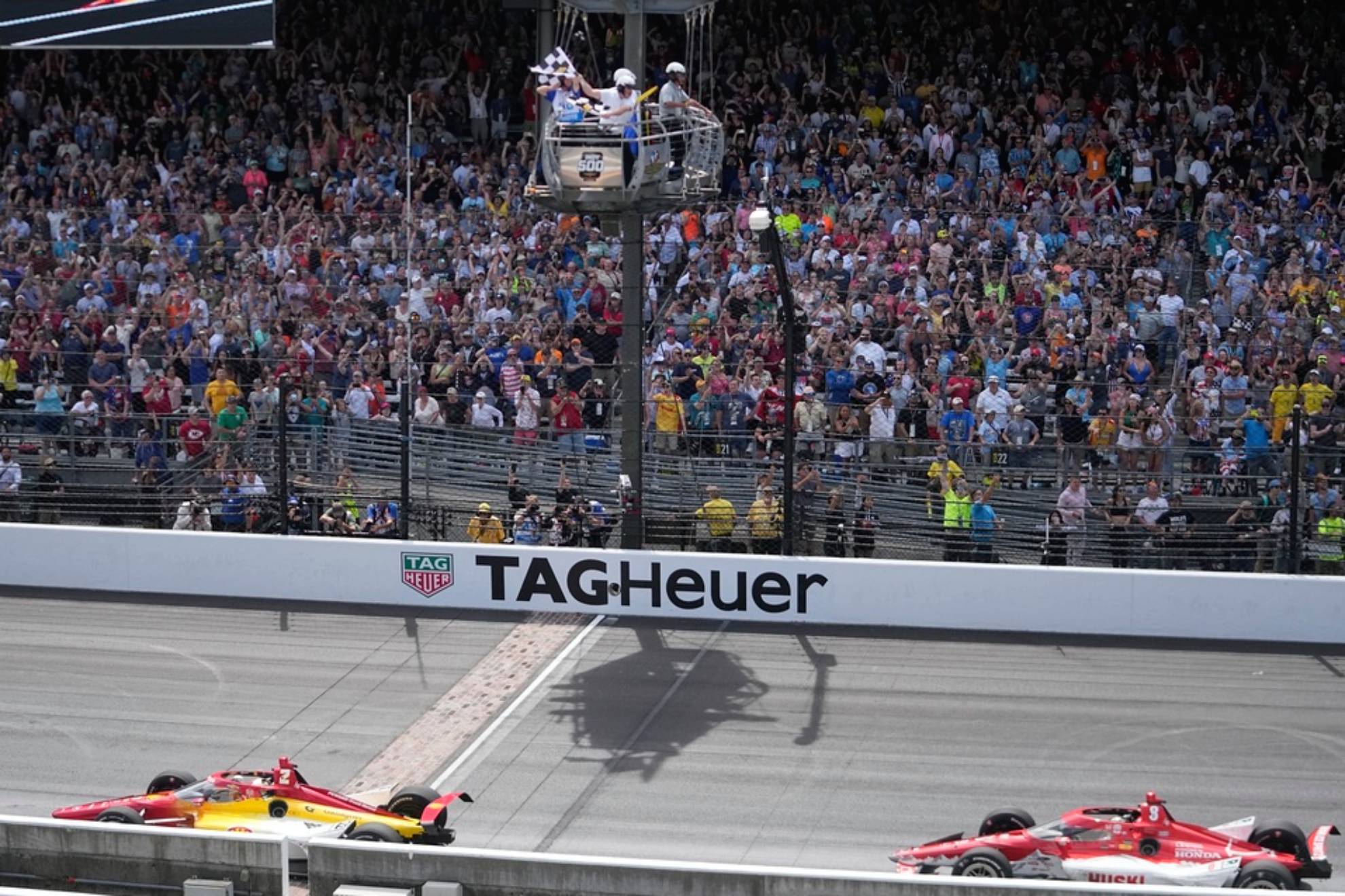 Josef Newgarden takes the checkered flag ahead of Marcus Ericsson, of Sweden, to win the Indianapolis 500 auto race