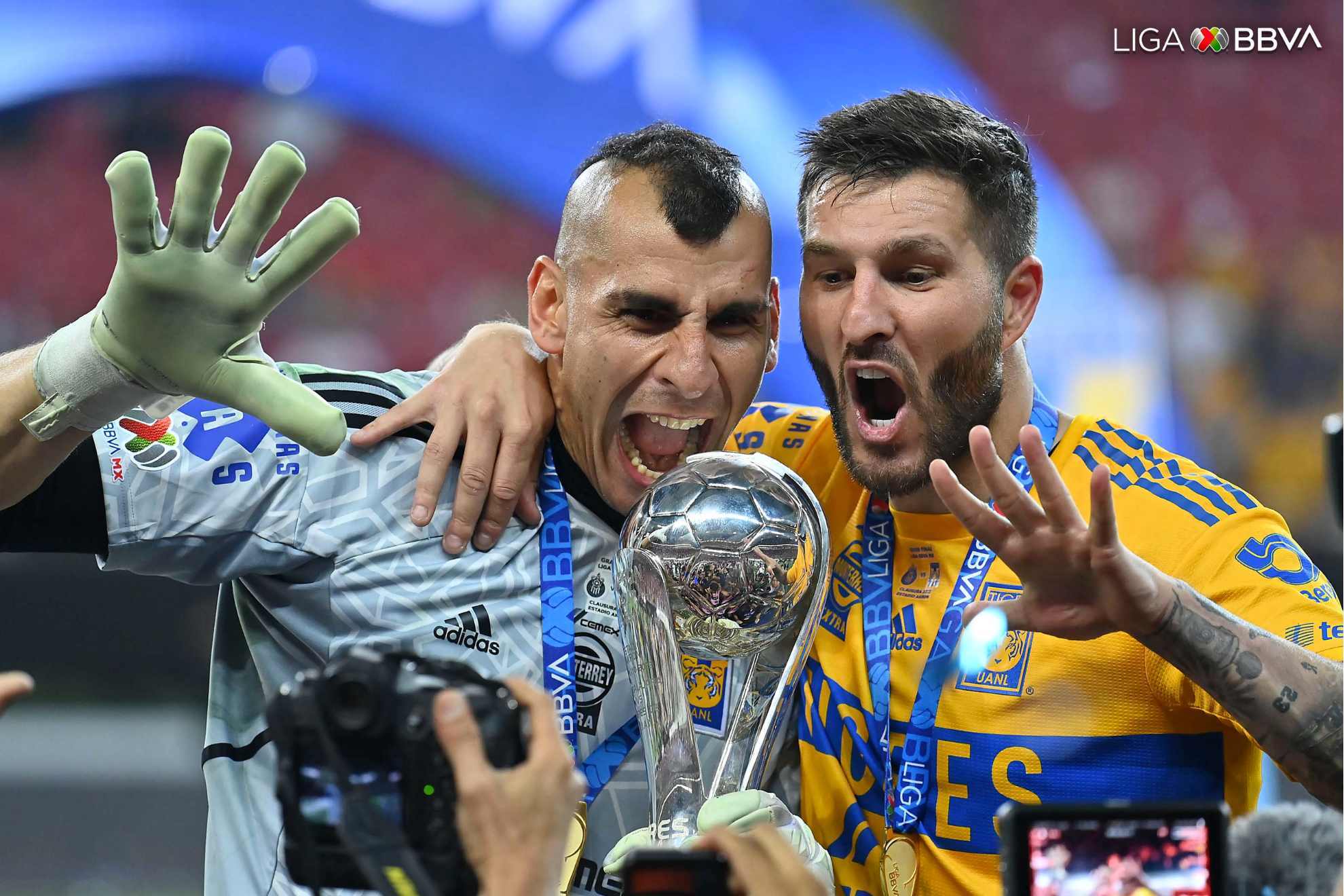 Nahuel Guzman and Pierre-Andre Gignac pose in front of the Liga MX Clausura trophy after an incredible comeback.