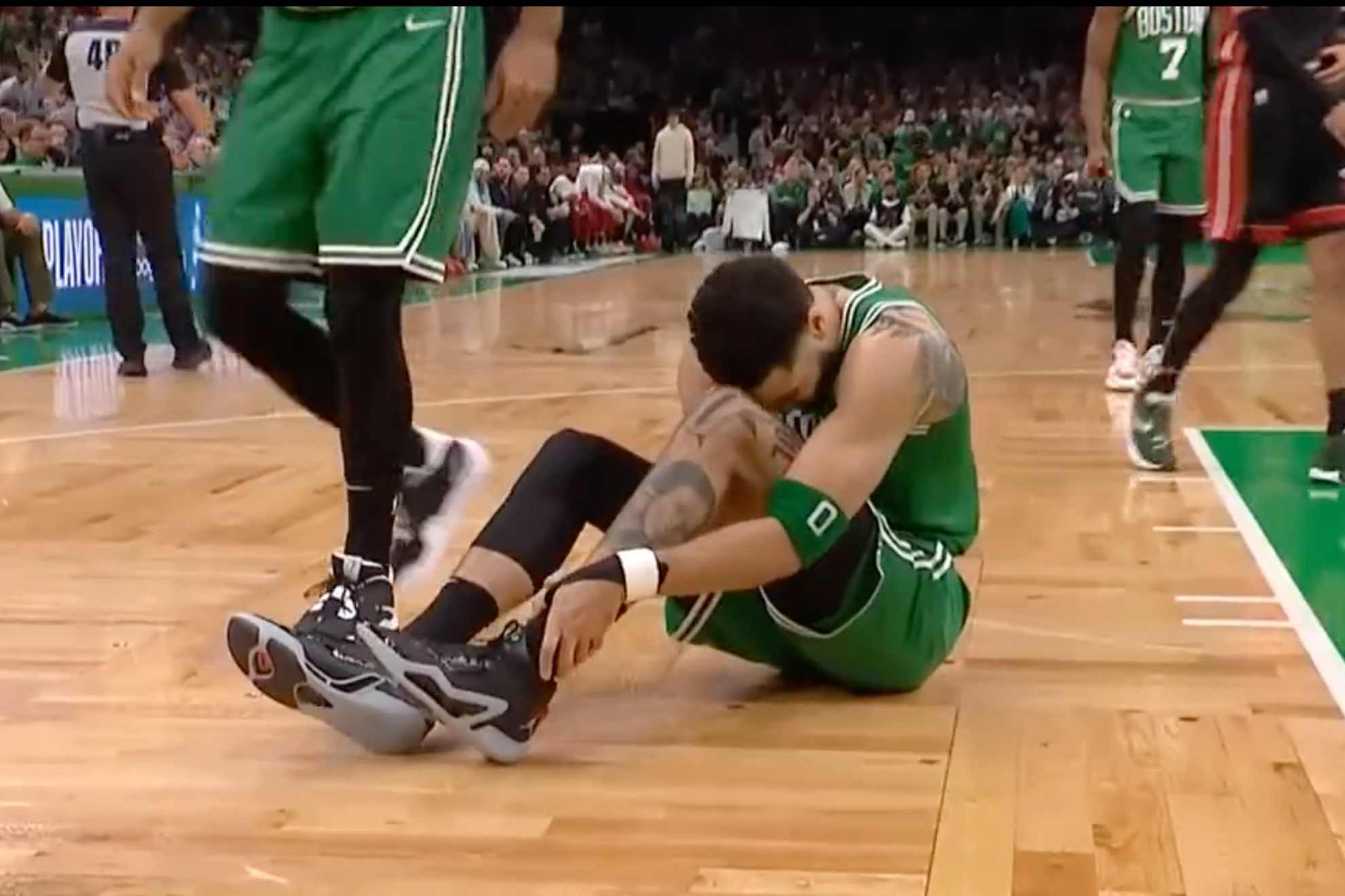 Celtics star Jayson Tatum clutches ankle in first play of Game 7 of NBA's Eastern Conference finals.
