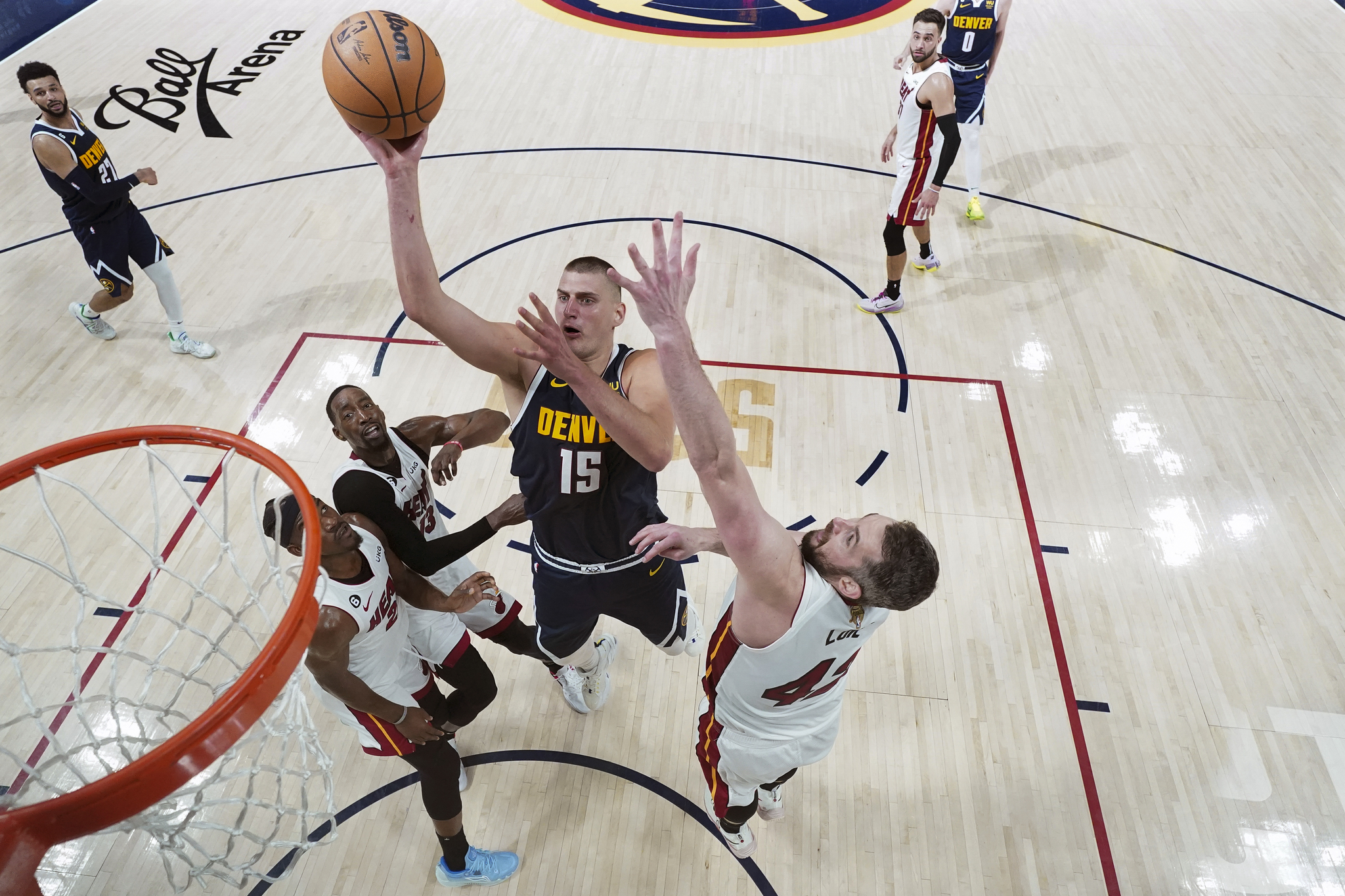 Denver Nuggets center Nikola  lt;HIT gt;Jokic lt;/HIT gt; (15) shoots while defended by Miami Heat forward Kevin Love, right, during the first half of Game 2 of basketball's NBA Finals, Sunday, June 4, 2023, in Denver. (AP Photo/Mark J. Terrill, Pool)