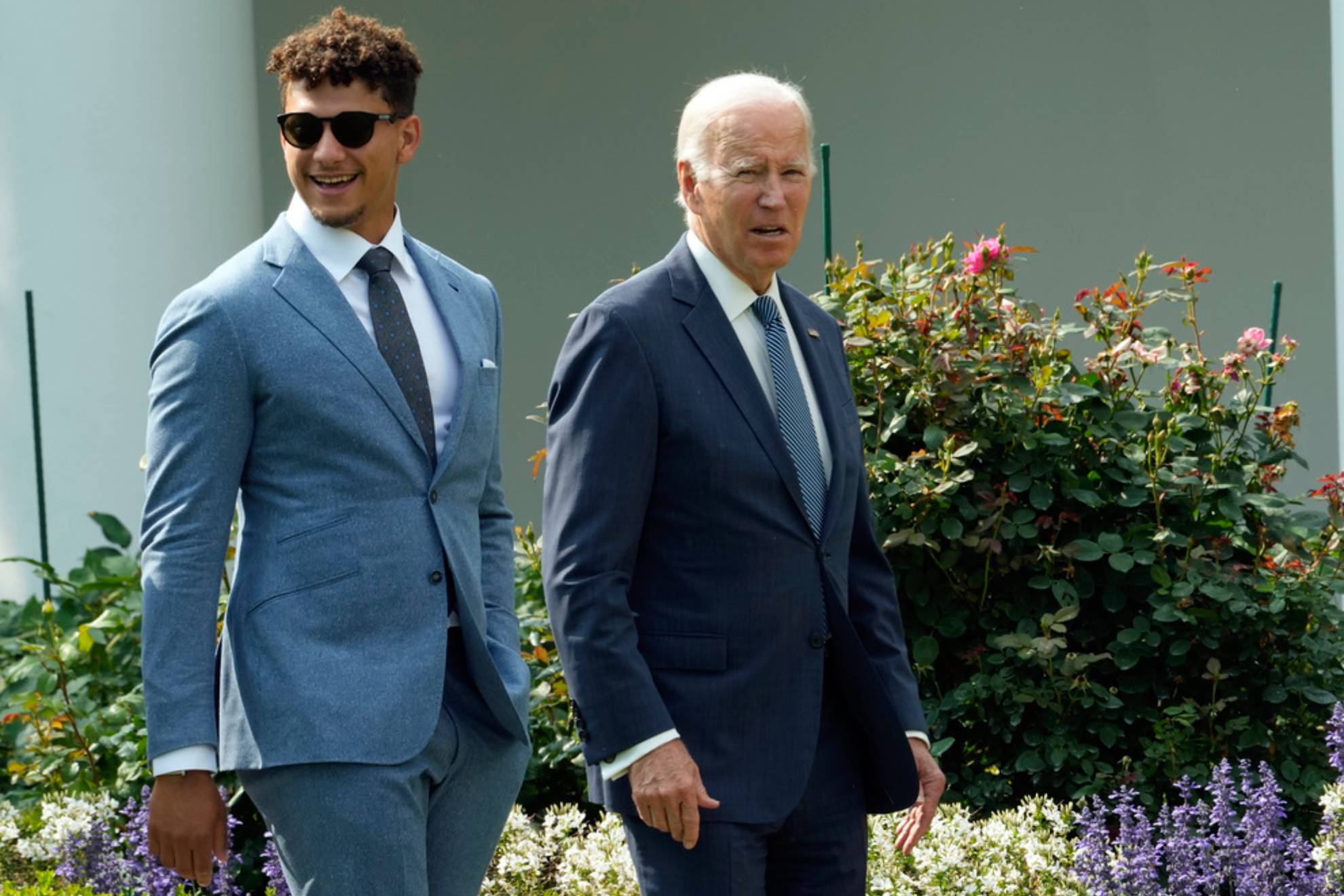 President Joe Biden walks with Kansas City Chiefs quarterback Patrick Mahomes