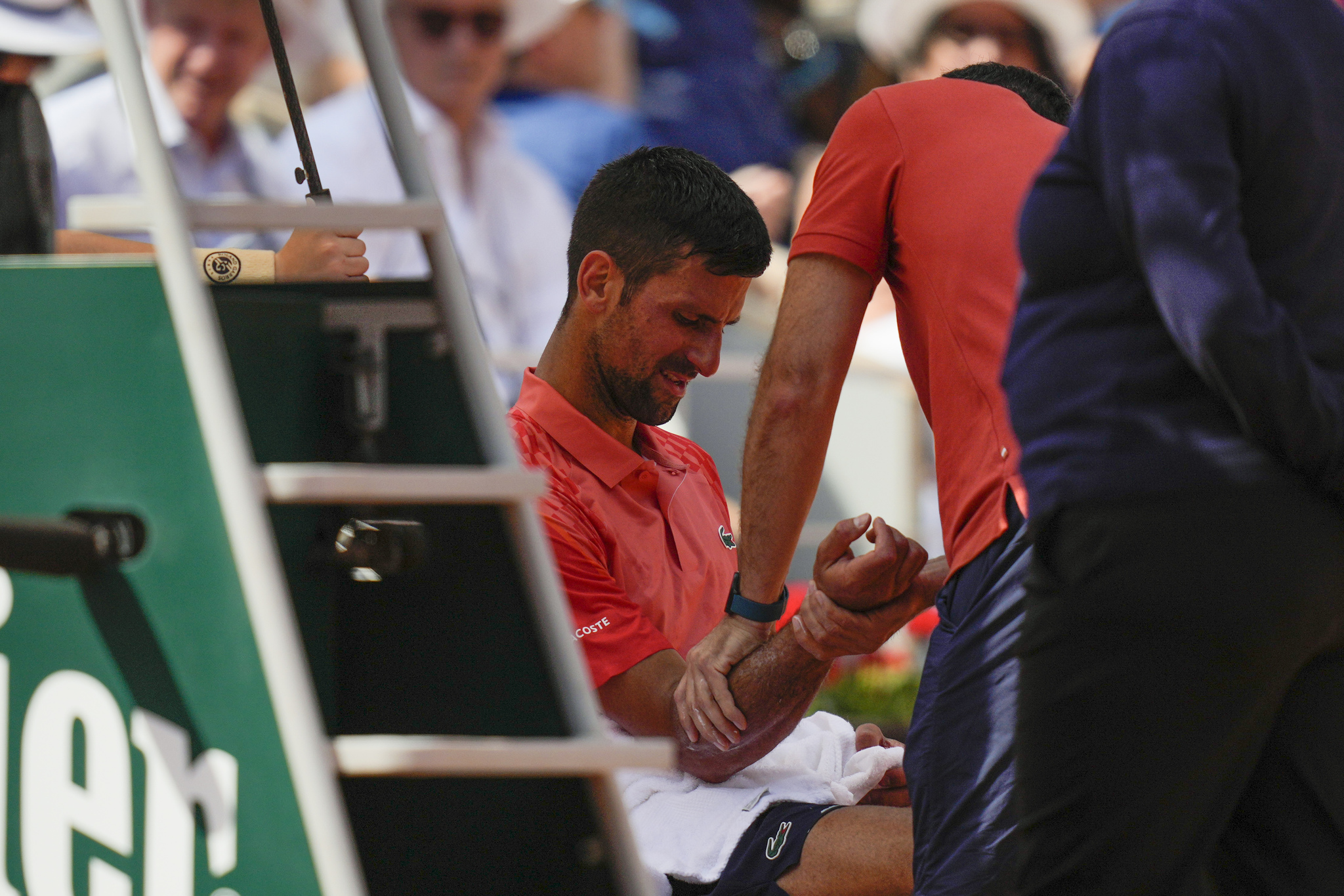 Serbia's Novak  lt;HIT gt;Djokovic lt;/HIT gt; receives medical attention for a right arm injury during the semifinal match of the French Open tennis tournament against Spain's Carlos Alcaraz at the Roland Garros stadium in Paris, Friday, June 9, 2023. (AP Photo/Thibault Camus)