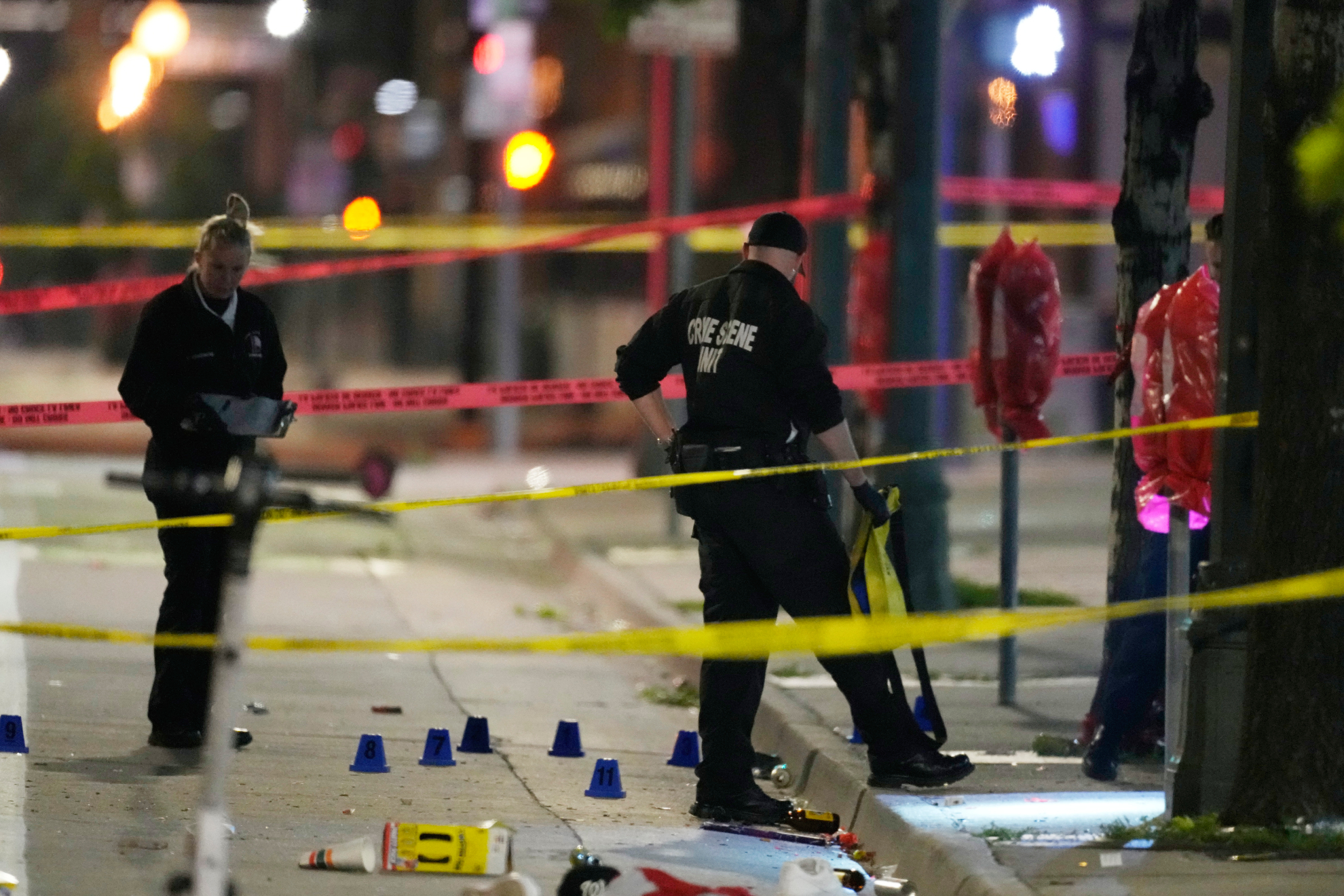 Denver Police Department investigators work the scene of a mass shooting along Market Street.
