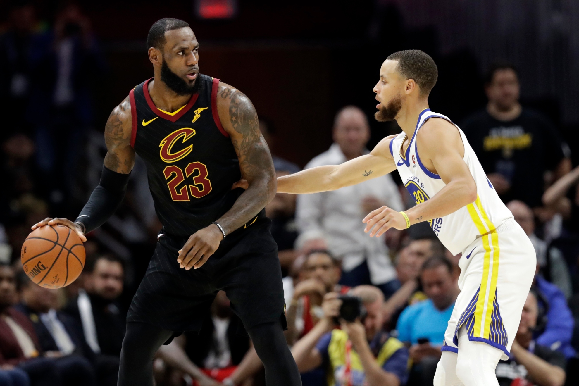 LeBron James guarded by Stephen Curry.