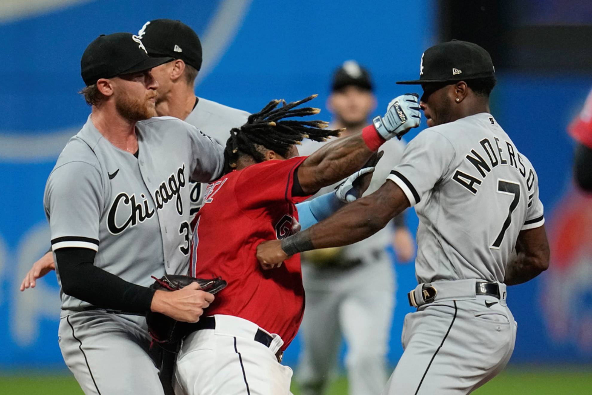 Cleveland Guardians Jose Ramirez, center, and Chicago White Soxs Tim Anderson (7) exchange punches in the sixth inning of a baseball game