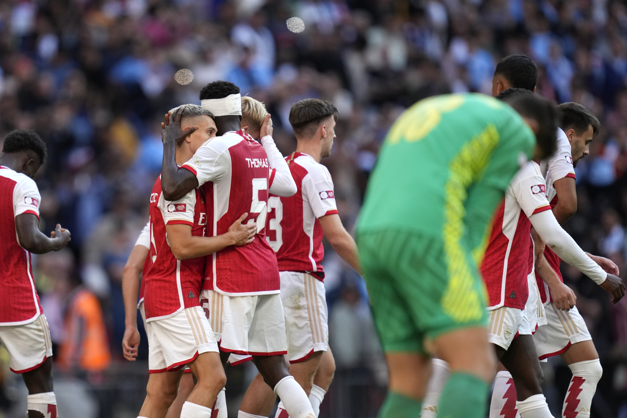 Arsenal players celebrate after Leandro Trossard scored