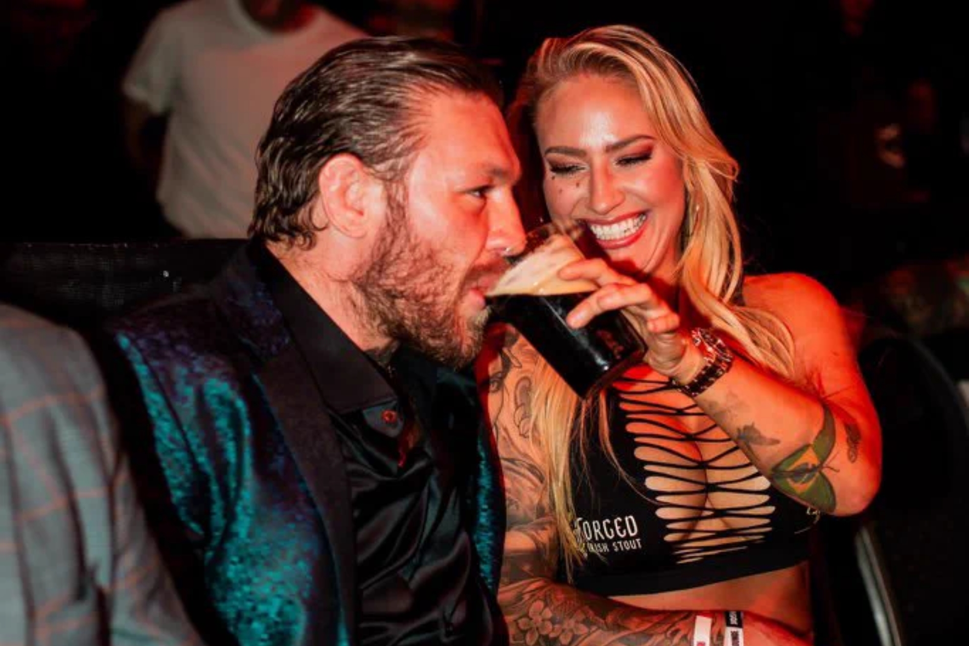 Conor McGregor taking some stout beer from Ebanie Bridges