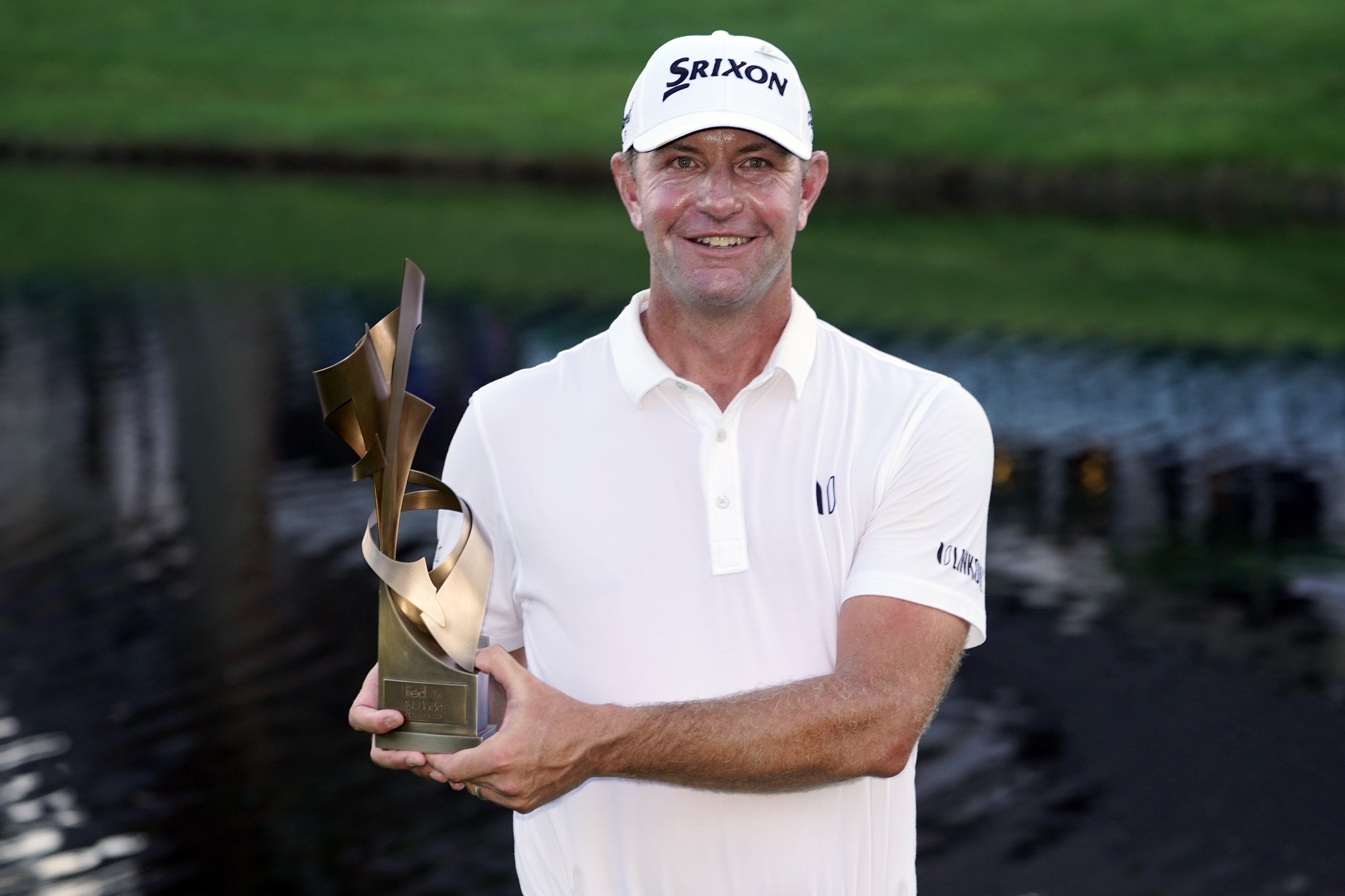 Lucas Glover holds the winner's trophy after winning the St. Jude Championship