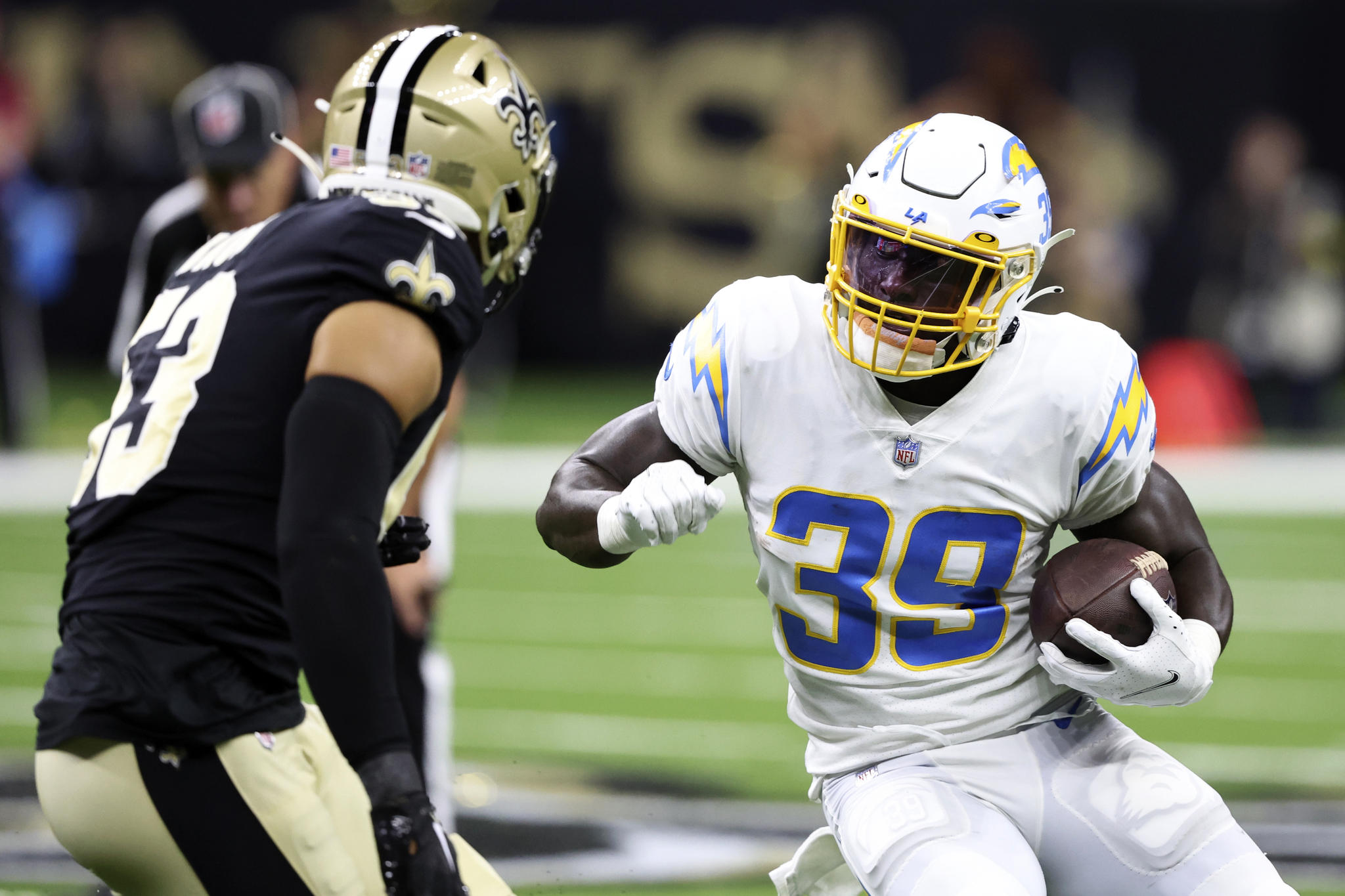 Los Angeles Chargers Kevin Marks Jr. runs from New Orleans Saints linebacker during last year's preseason game.