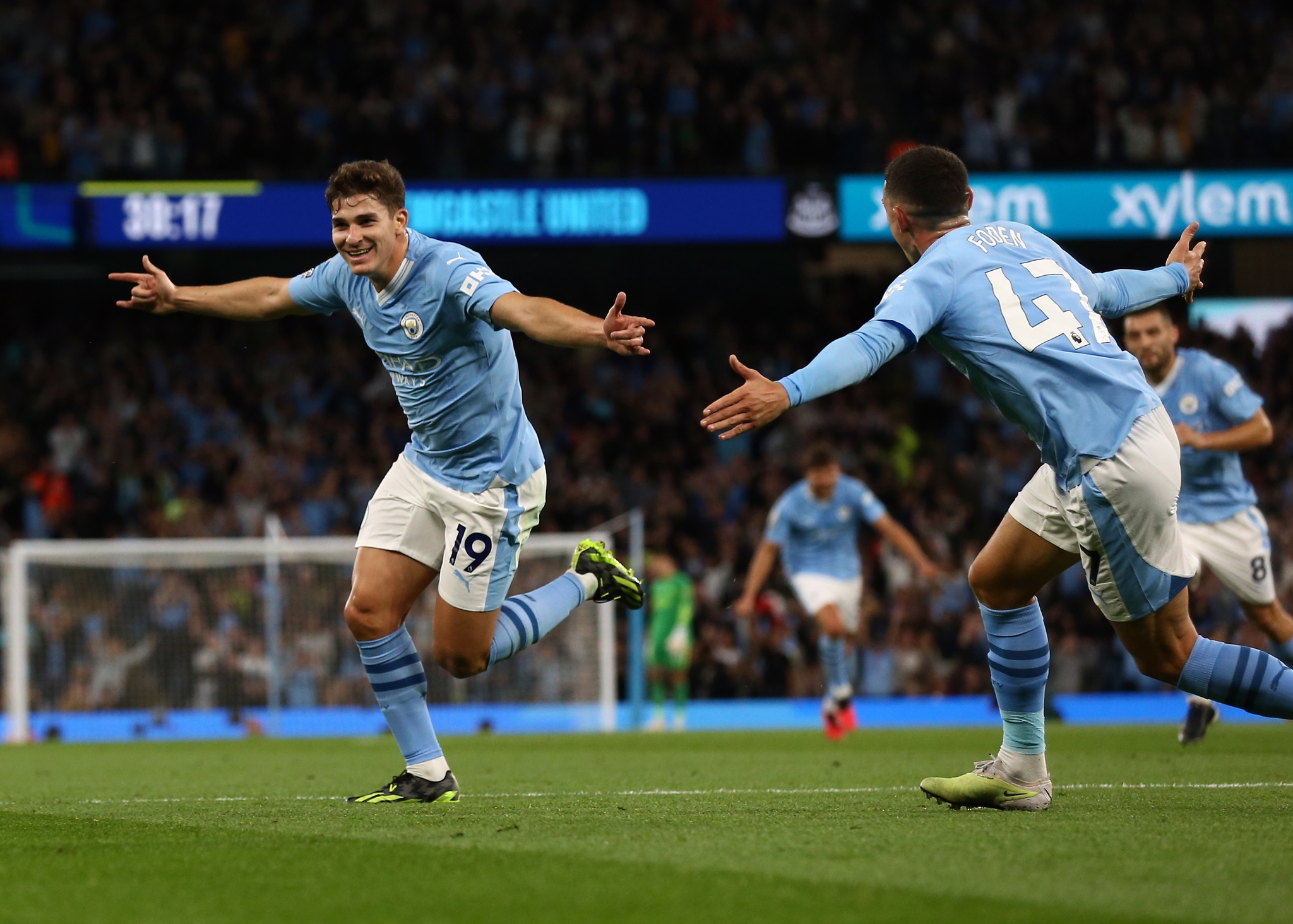 Manchester City's Julian Alvarez celebrates with Phil Foden