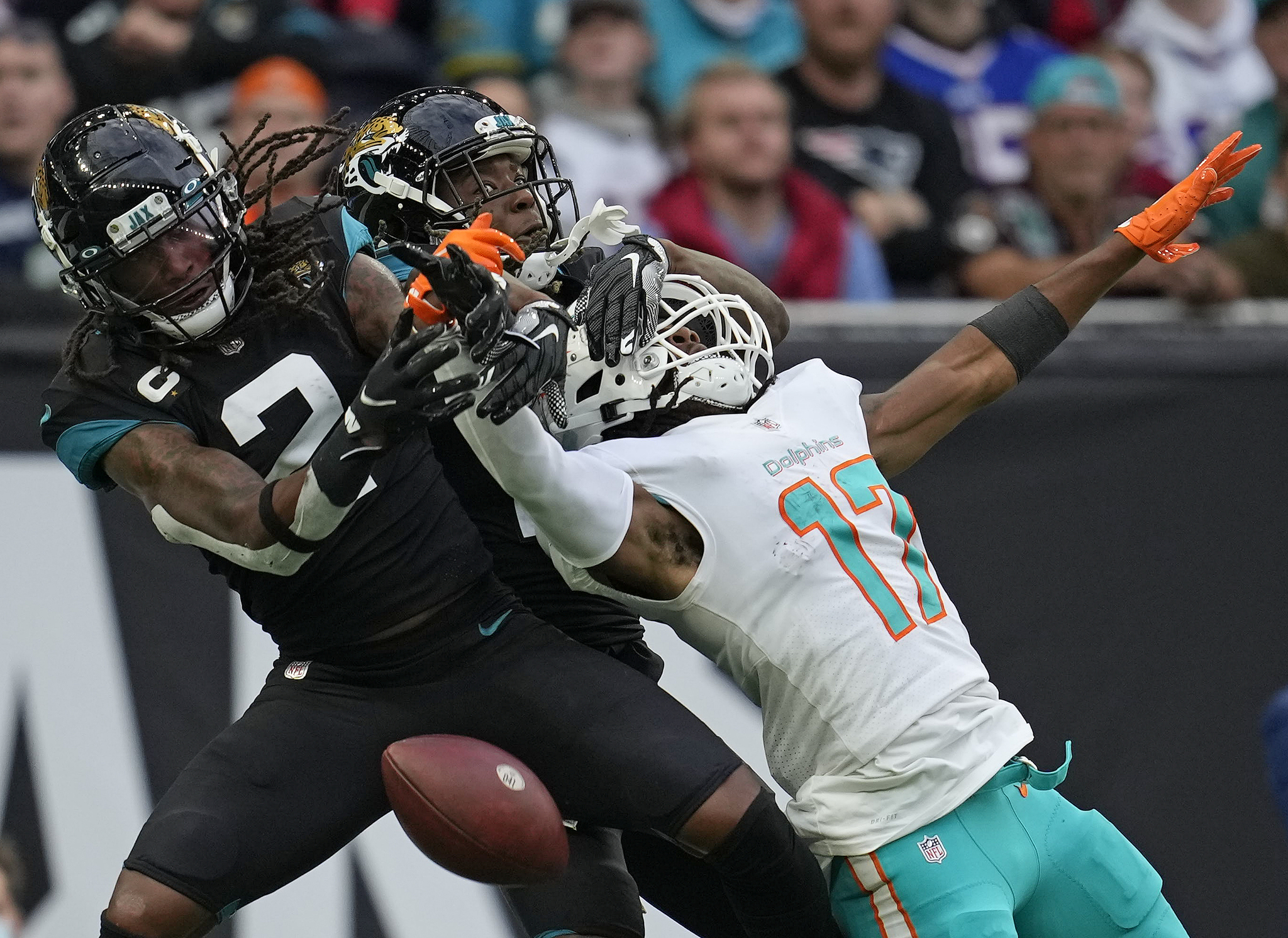 Miami Dolphins wide receiver Jaylen Waddle is challenged by Jacksonville Jaguars free safety during the second half of their last game.