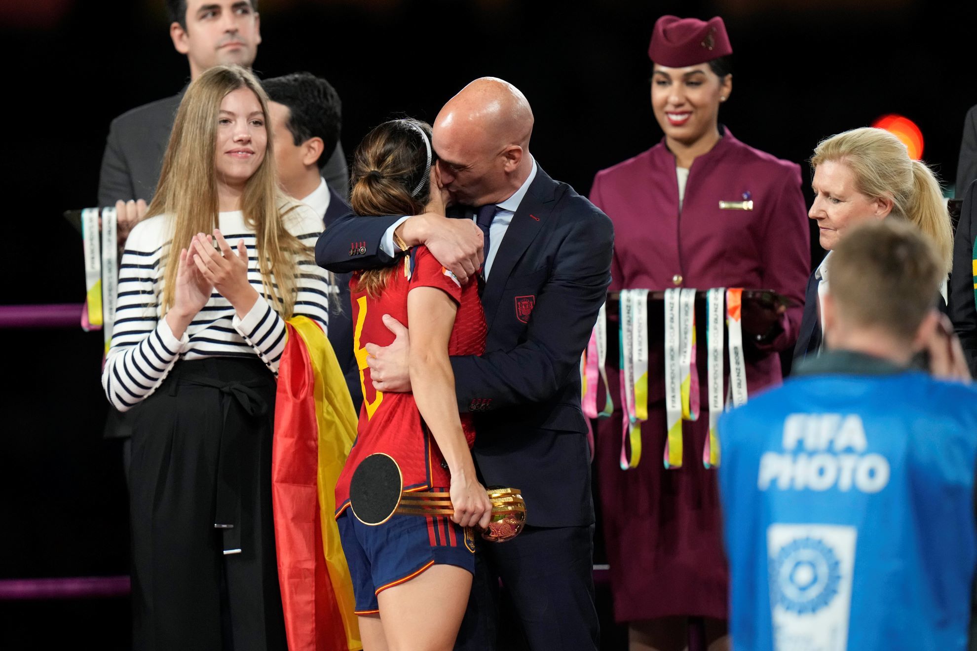 President of Spain's soccer federation, Luis Rubiales, right, hugs Spain's Aitana Bonmati on the podium.