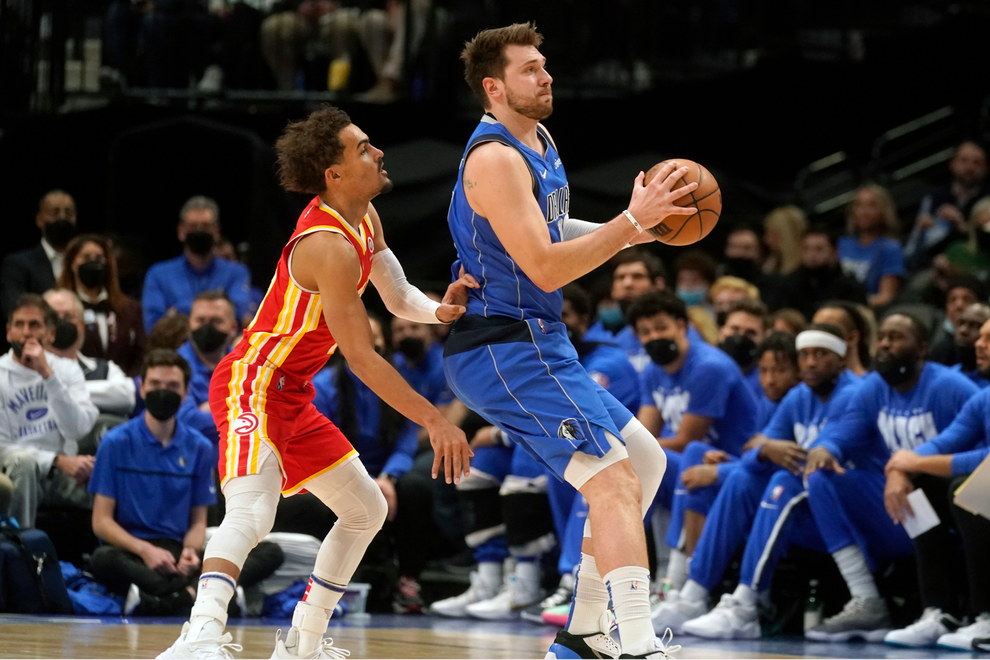 Trae Young and Luka Doncic face each other during an NBA regular season game.