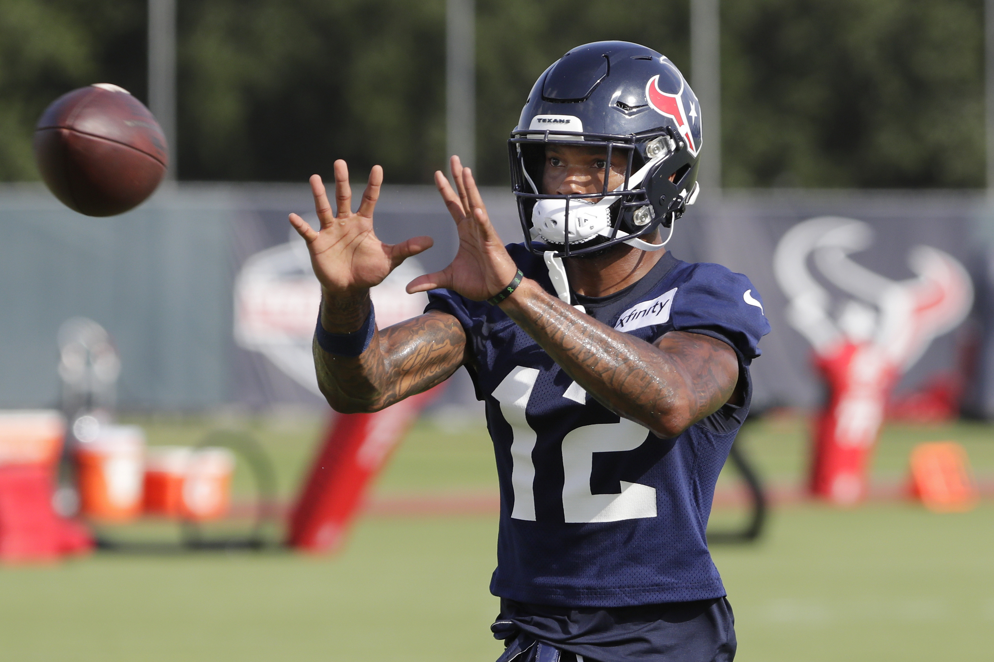 Nico Collins catches a ball during training camp.