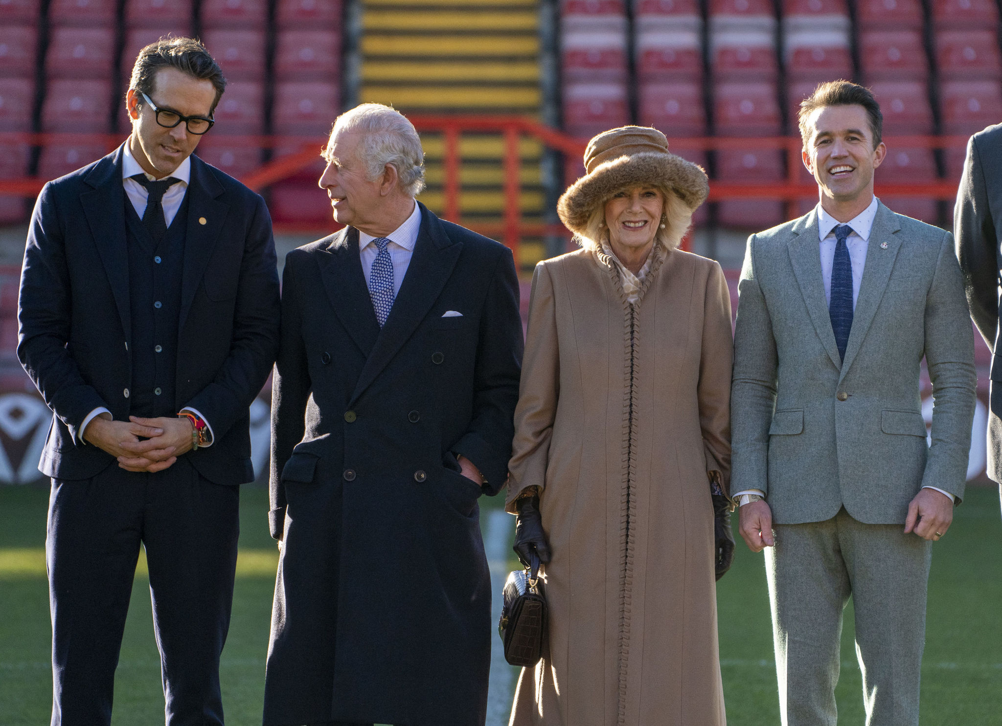 Britain's King Charles III, centre left and Camilla, the Queen Consort, centre right and Wrexham co-owners Ryan Reynolds, left and Rob McElhenney