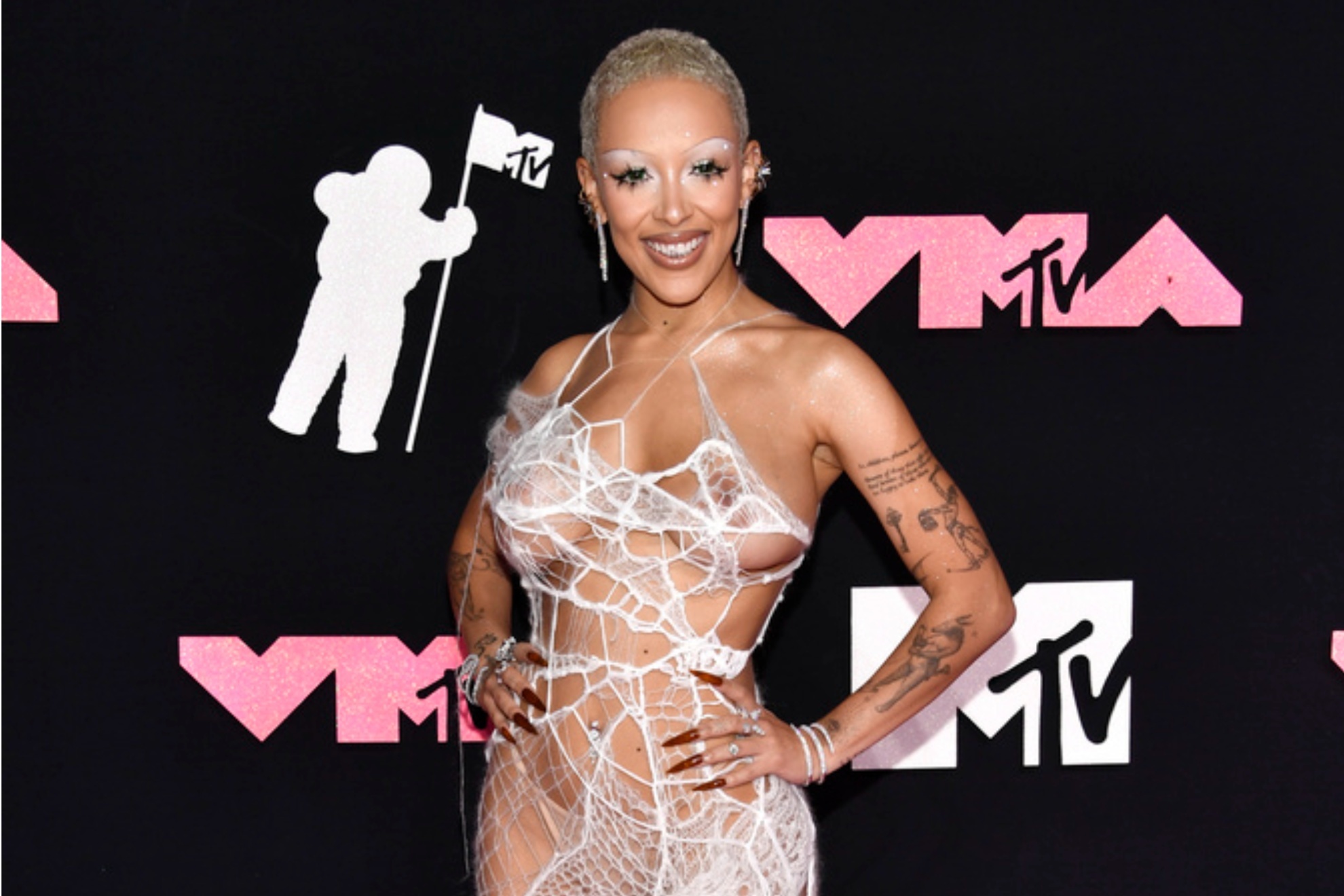 Doja Cat arrived to the pink carpet of the MTV VMAs in a sheer spider web dress