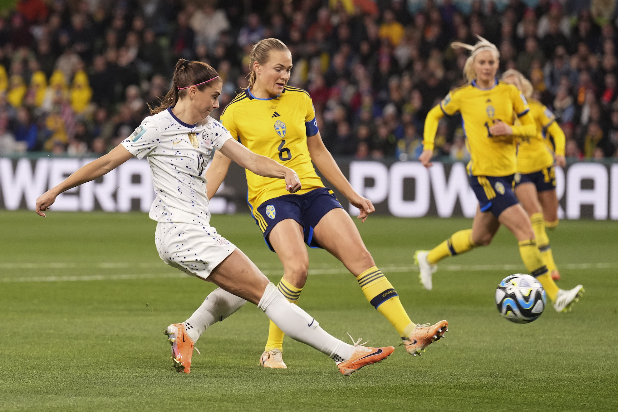 United States' Alex Morgan, left, takes a shot at goal as Sweden's Magdalena Eriksson watches during the Women's World Cup round of 16 soccer match between Sweden and the United States in Melbourne, Australia, Sunday, Aug. 6, 2023