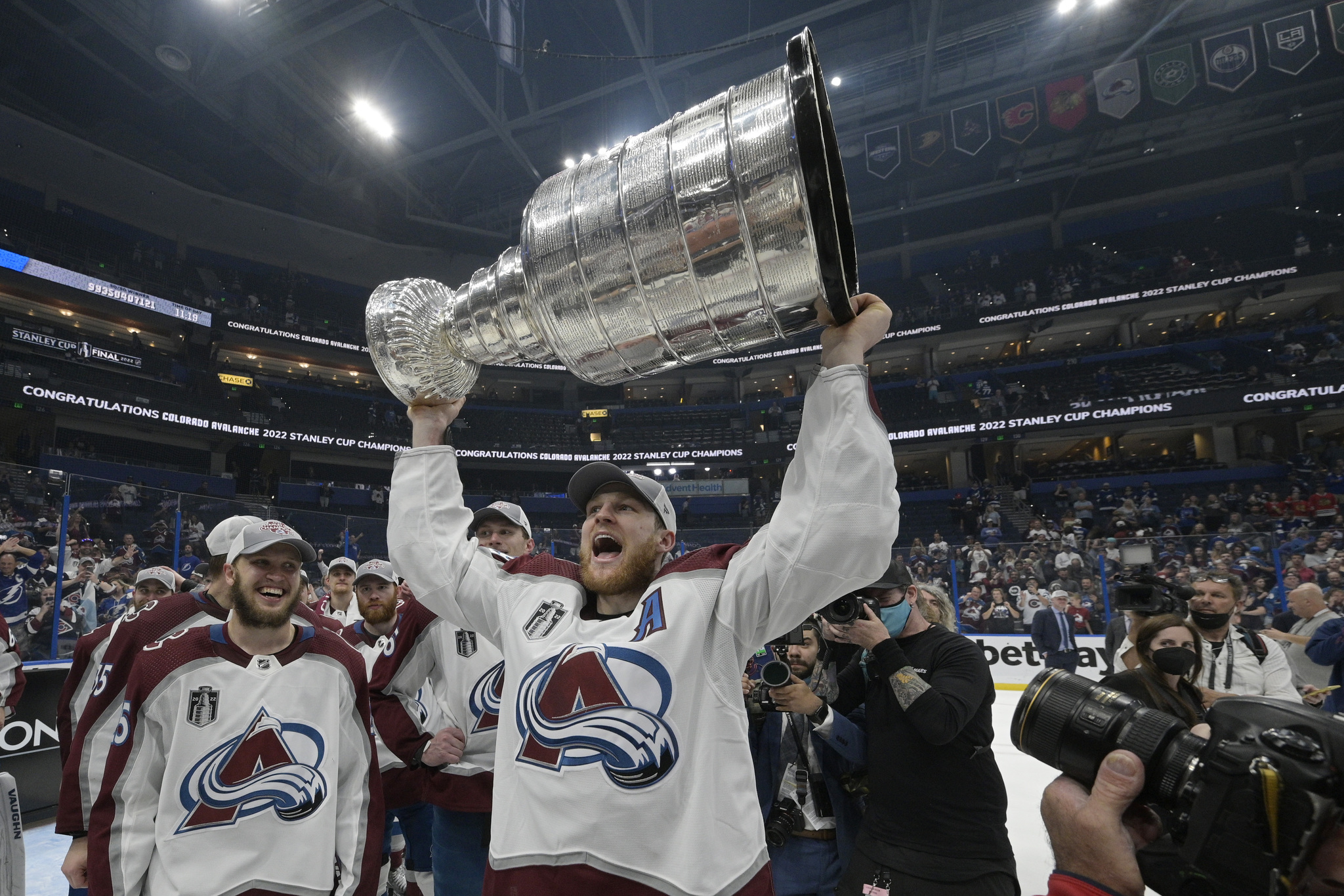 Colorado Avalanche center Nathan MacKinnon lifts the Stanley Cup