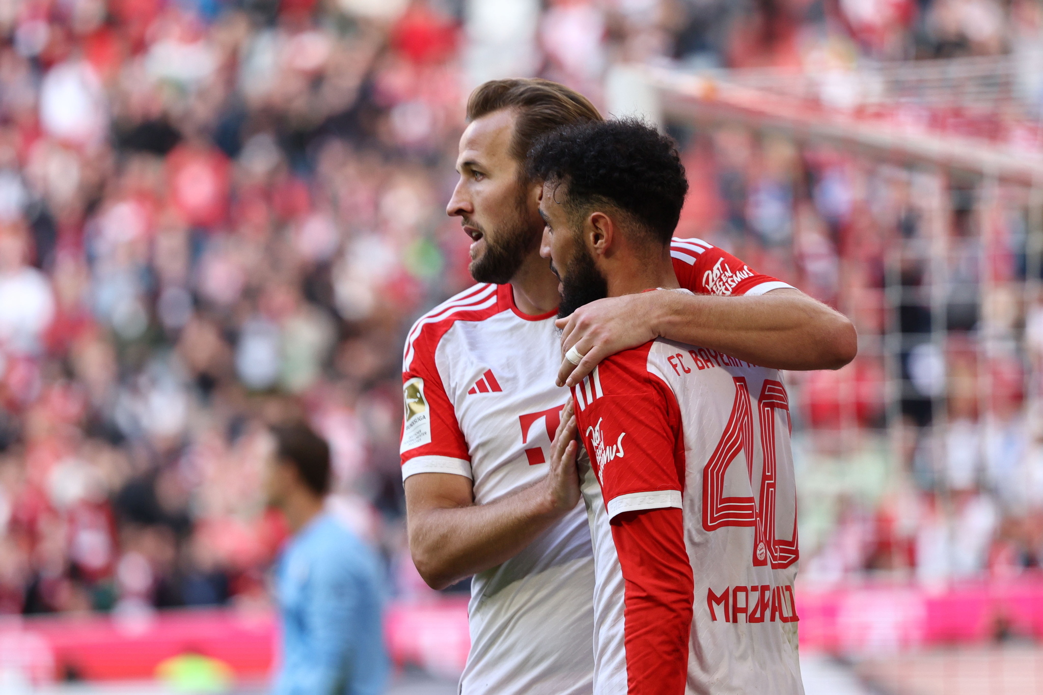 Bayern Munich's Harry Kane (L) celebrates with teammate Noussair Mazraoui (R)