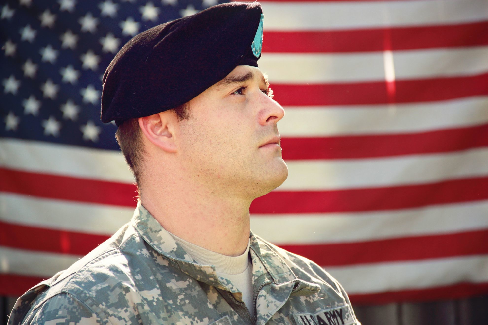 Combat veteran honoring the American flag