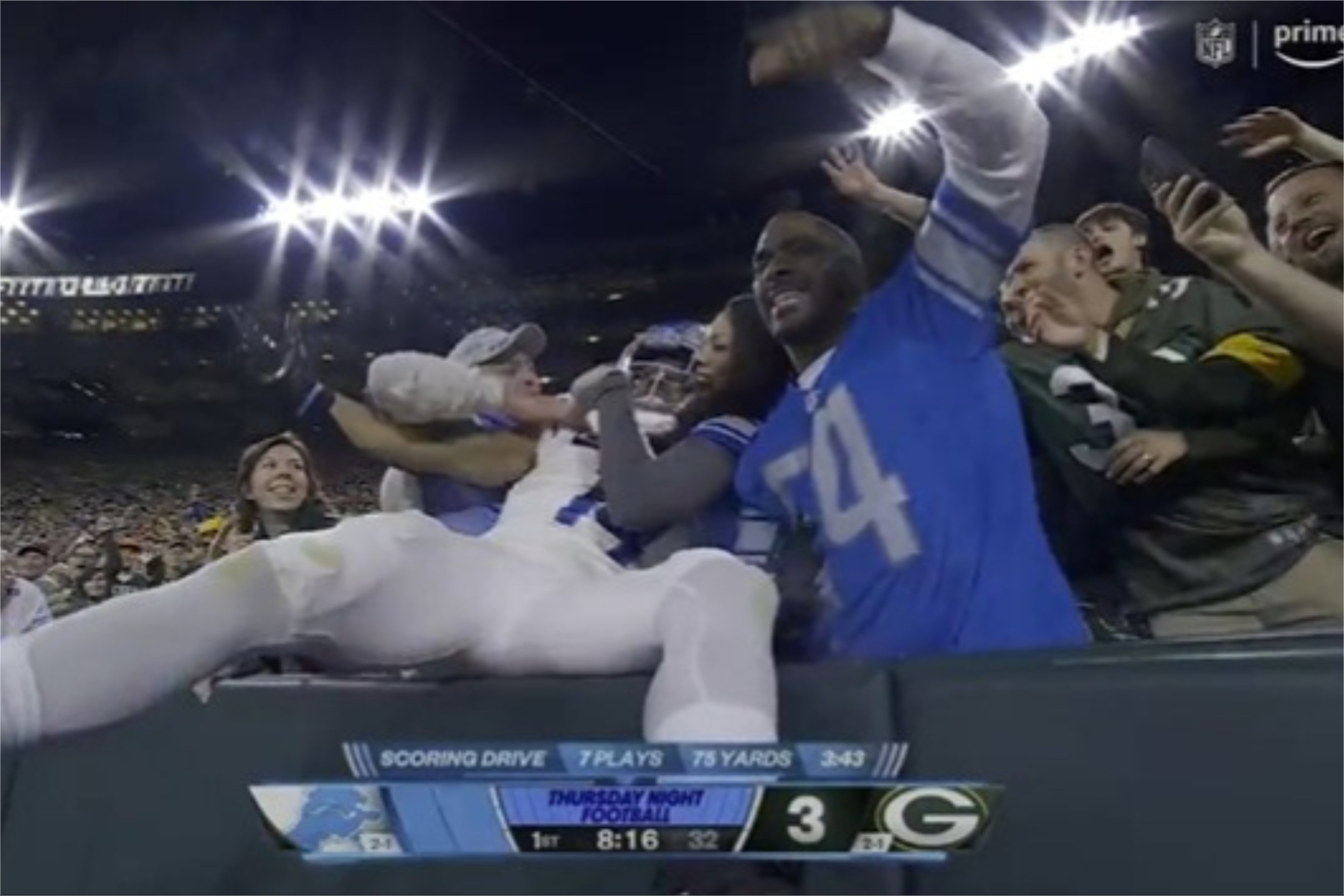 Lions' Amon-Ra St. Brown made a Lambeau Leap after scoring the first touchdown of TNF