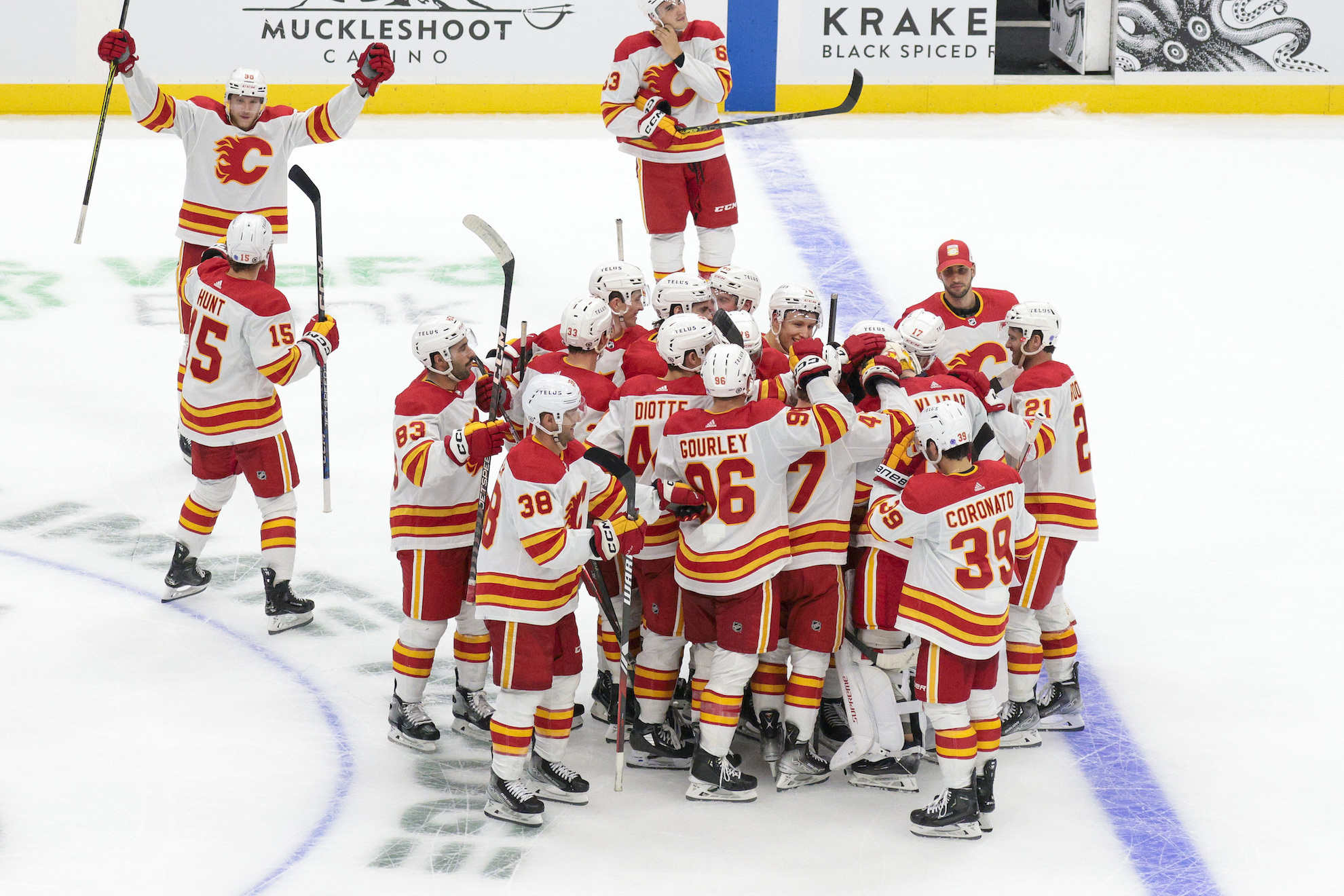 Calgary Flames players celebrate their win in the overtime shootout period of an NHL preseason hockey game against the Seattle Kraken Monday, Sept. 25, 2023, in Seattle. (AP Photo/Jason Redmond)